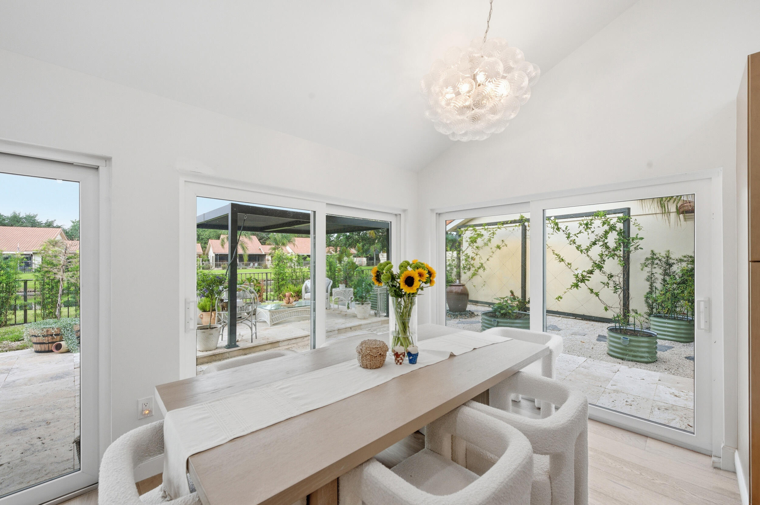 Welcome to this newly renovated Mediterranean/Spanish-style one story home w/ 3 BR, 2 bathroom +  2 car garage. Easy access to downtown West Palm Beach, beaches, shopping, groceries, PBI Airport + highways. MAJOR reno + upgrades (200K+) inc. roof (2022), HVAC (2026), full impact windows + sliding doors (50K+), luxury European oak flooring (35k) (2025) water heater (2022) opened kitchen added pot filler over stove + ALL appliances in 2025,, whole-home water softening system + SO much more. The private backyard has new professional landscaping {35k) + lighting. Need more space? Easily add stairs for a loft in the 2nd bedroom! Enjoy dramatic vaulted ceilings + spacious open floor plan. HOA includes Landscape, Wifi, trash, sidewalk, clubhouse, pool, Pickleball, etc. (Reno list continued) Here are full details on the 200k+ renovations ---   Interior renovation - 110K * Full renovation interior: flooring, ceiling, paint/walls, lighting, cabinetry, bathroom renovations * Highlights: modernized open concept design, french oak and stone flooring, freestanding tub, dual vanity, and walk in shower in master bathroom, all new cabinetry and granite countertops, all new appliances and washer/dryer, open concept kitchen, all new high-end light fixtures Exterior Renovation - 35K * Full backyard renovation including a fire pit, stone flooring, pergola and outdoor garden, full landscaping replacement (back yard/front yard) Additional updates since purchase: * Window/sliding door replacement (2026) - 50K (all hurricane proof, energy efficient double pane windows/doors) * HVAC Unit replacement- 10K (2026) * All new lighting and appliances- 5K