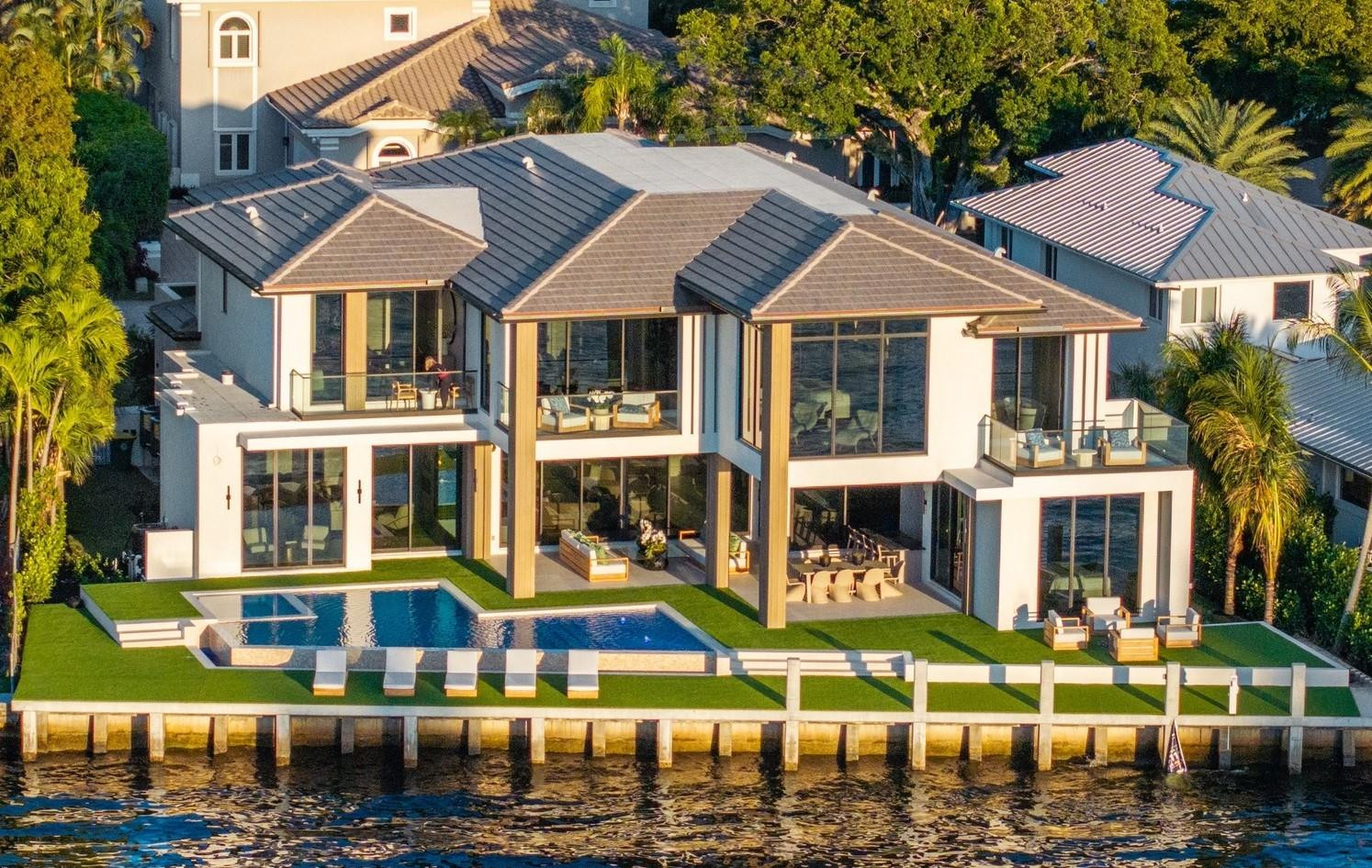 This NEW construction Intracoastal estate completed June 1, 2025 in prestigious Sea Ranch Lakes is a masterpiece of ultra-luxe design. Residents of this exclusive, gated community have peace of mind in this police protected Village. 9,200 total sq ft, all the newest technology, integrating indoor/outdoor living w/sliding glass walls, east/west light filled views and intracoastal breezes.  This turnkey home with 110’ of waterfront features elegant millwork, 300 bottle wine display, infinity pool, generous sized bedrooms and bathrooms. Primary bedroom features separate bathrooms & luxurious walk-in closets. Additional features include elevator, clubroom, 3-car garage, boat dock, generator ready & lush landscaping, private Beach Club. Located minutes from prestigious Pine Crest School.
