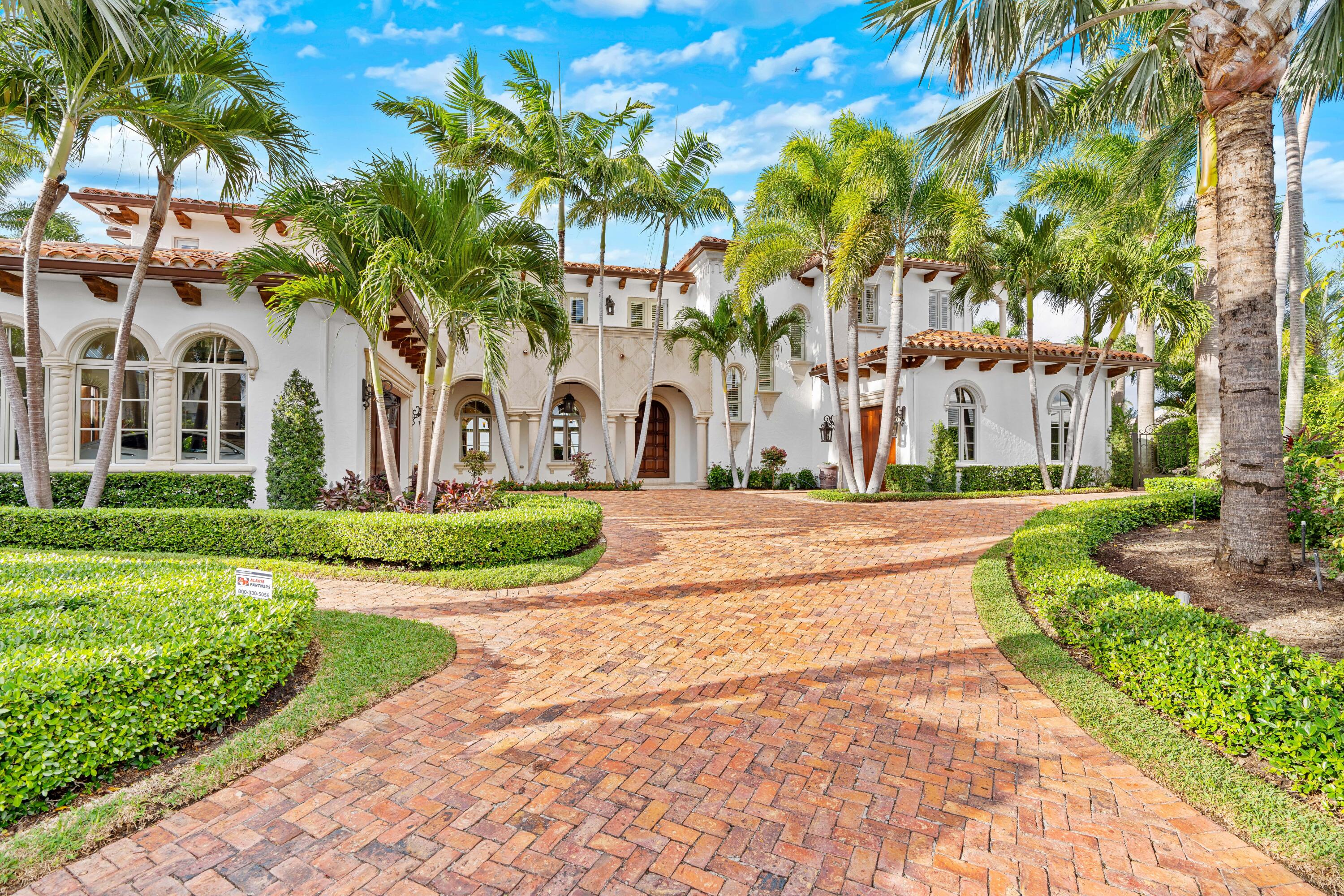OVER 230FT OF WATERFRONT. Accommodates a 100ft vessel. Rare panoramic views of one of the WIDEST SECTIONS OF THE INTRACOASTAL. This corner lot has a boat lift on the Northside of the property & accommodates another boat on the Westside. The 9,850SF home has a beautiful outdoor space: oversized loggias & terraces, summer kitchen & 50-ft infinity pool overlooking the water. Inside: 5beds w/private en-suite baths. Elevator leads to the master suite: private balcony, water views, dual closets & private laundry. Living area: open kitchen w/2 center islands, Wolfe stove, double ovens, granite counters, high-end appliances, custom lighting, grand dining room & living room. Built in '08 the home has a private study & multi-purpose area. Hurricane impact windows. Near ocean, restaurants & shopping. OVER 230FT OF WATERFRONT. Can accommodate a 100ft vessel. Rare and breathtaking panoramic views of one of the WIDEST SECTIONS OF THE INTRACOASTAL. This special corner lot has a boat lift on the North side of the property and could also accommodate another boat on the West side. This spectacular 9,850 SF home has a beautiful outdoor space, oversized loggias & terraces, summer kitchen, and a 50-ft infinity pool overlooking the water. Inside, the home features 5 bedrooms, each with an en-suite bath. An elevator leads up to the master suite with a private balcony, direct water views, very spacious dual custom closets, and a private master laundry room.  The living area includes a large open kitchen with two center islands, Wolfe stove, double ovens, butler's pantry, granite counters, top-of-the-line appliances, and custom lighting throughout... as well as a breakfast nook, a grand dining room, and a living room. The home, built in 2008, also includes a private study and a multi-purpose area, perfect for a fitness room. Features include custom moldings and hurricane impact windows throughout as well as hand-carved coral stone fireplaces, and Pecky Cypress beams. Located minutes away from the ocean, restaurant, and shopping.