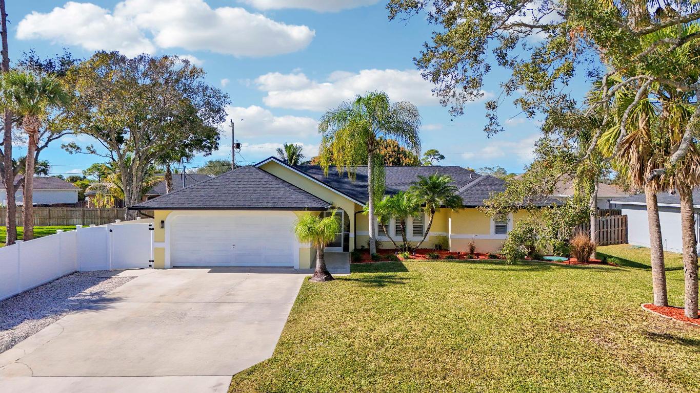 Must see to Believe!! Upgraded 3/2/2 with screened in pool, 2025 roof and gutters, freshly painted, mature landscaping, vinyl fence around rear and side yards, 10x10 shed.  Interior with vaulted ceilings, central vac, custom master closet, updated bathrooms, oak hard woods in bedrooms, porcelain tile throughout main areas and baths, 6'' baseboards.  Granite countertops, LG and Bosch appliances, tankless water heater, new A/C and much more. Close to dining, shopping, Schools, Tradition and I95, Don't wait, call today for an appointment.