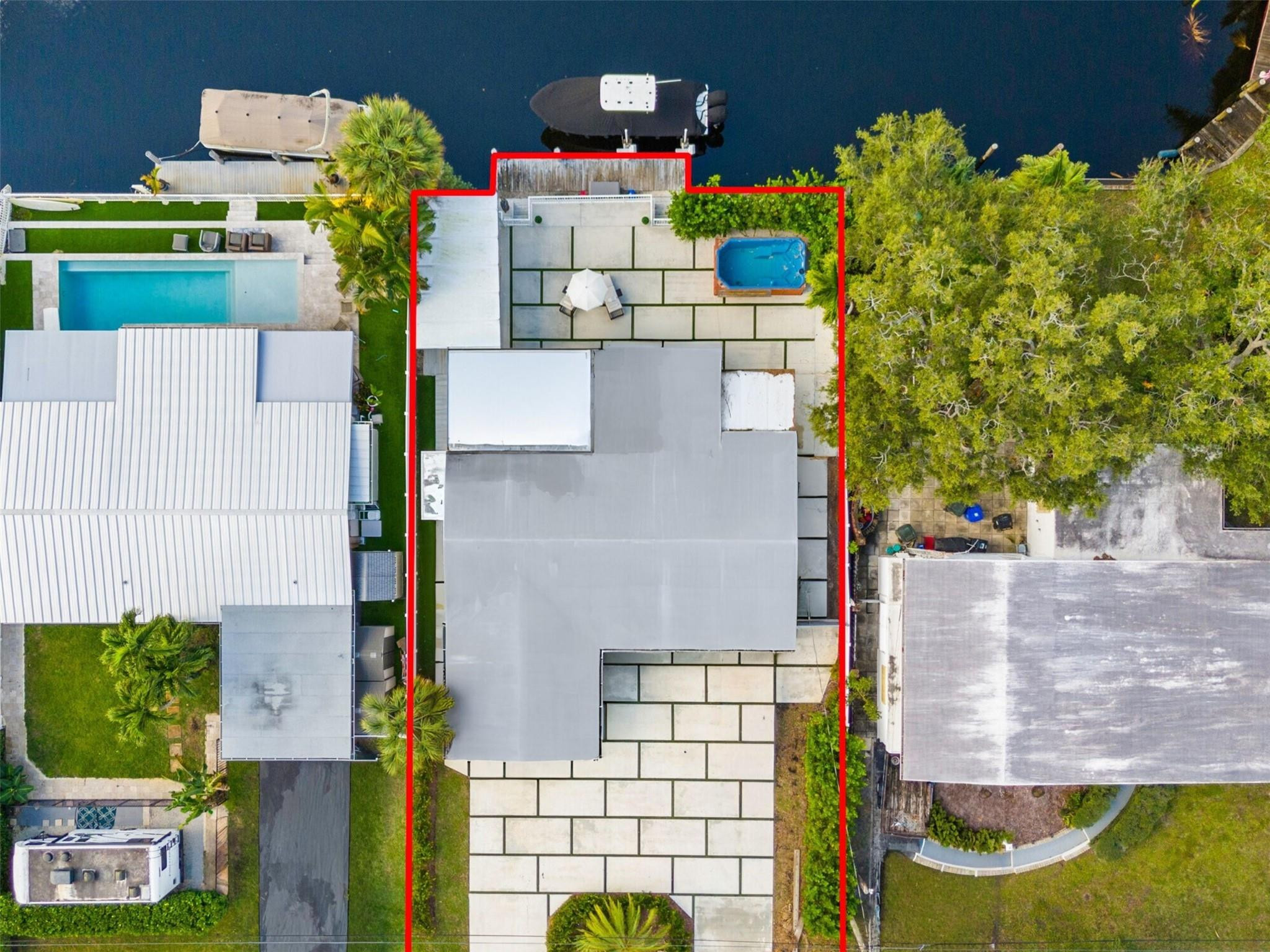 Turn-key 3-bed, 3-bath ocean-access waterfront home in Lauderdale Isles, Fort Lauderdale. This 2015 full-rebuild features 65' of deep-water frontage, a private dock, 55' bridge clearance, and no fixed bridges; perfect for large vessels. NO HOA! Inside this rare floorplan, find 3 private en-suite bedrooms, high-impact windows/doors, and a gourmet kitchen with oversized quartz countertops. Recent upgrades include a 2017 roof, 2020 HVAC, and 2016 tankless water heater. The outdoor oasis boasts two waterfront terraces, a custom BBQ kitchen with open-flame burner, a 74' retaining wall, and a private oversized jacuzzi. Additional features: custom security system, AC-equipped storage, and an oversized U-shaped circular driveway. Move-in ready- ideal for boaters and entertaining!