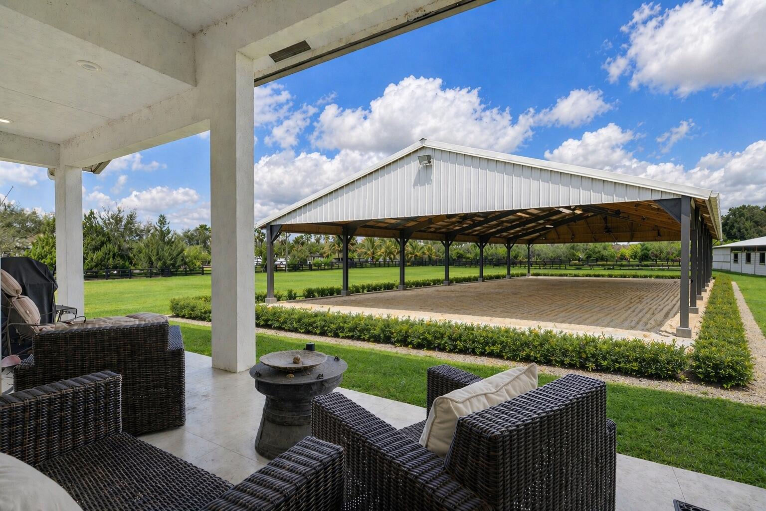 NEW CONSTRUCTION equestrian retreat set on cleared, elevated land, backing to a protected bird sanctuary with a private entrance to miles of horse trails. The 2023 built modern home offers 4 bedrooms plus an office/ den, 3 full baths, hurricane-impact windows and doors, a new upgraded A/C, and a whole-property reverse osmosis water system. Horse facilities include a NEW 2024 European-style barn with twelve 12' x 12' stalls, ceiling fans and stall fans, and 7 stalls have 48-ft runs and gated access for easy turnout. The property also features six oversized 46' x 46' paddocks, additional 12' x 46' gated paddocks, and connected paddocks with gates allowing for flexible group turnout. Two wash racks, tack and feed room, bathroom and mudroom. Quiet and private, with two separate driveway and RV hook up. Located in a gated equestrian neighborhood, White Fences Showgrounds located INSIDE this neighborhood! Also right off of Southern Blvd by Wellington Showgrounds- IDA, WEF, Polo Center. Zoned for Wellington's A Rated schools!