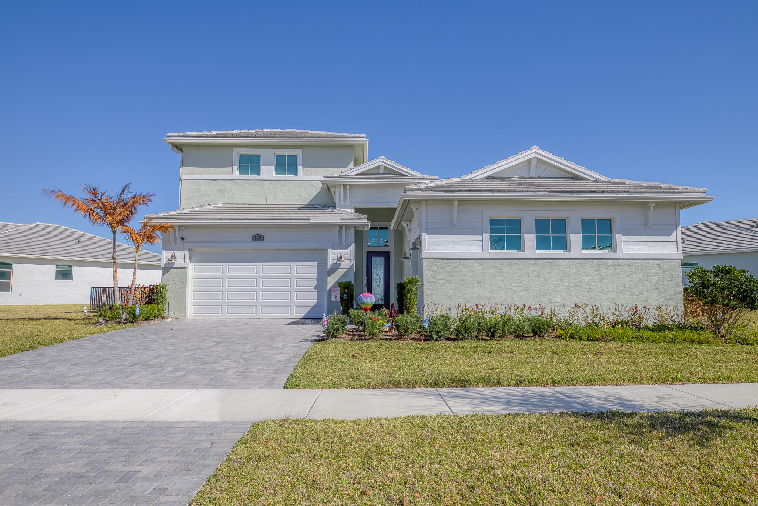 Welcome to elevated Florida luxury living in PGA Verano, one of Port St. Lucie's most prestigious communities. Situated on a premium lakefront lot w/ a $90,000 lot upgrade & easements on both sides for added privacy, this stunning home offers 4 bedrooms, a den/office & 4 full bathrooms. Thoughtfully upgraded throughout with fresh interior paint, wet bar, pantry, whole-home water filtration w/ Grundfos pump, and sealed pavers on the driveway and patio/pool area. The open-concept living space features custom built-in entertainment cabinetry w/ accent lighting & an electric fireplace. Enjoy indoor-outdoor living with ceiling fans inside & out, remote-controlled blinds on the lower level, blinds upstairs & a built-in outdoor kitchen overlooking the lake. Used golf cart included with purchase. Beyond the home, residents enjoy the unmatched resort-style lifestyle of PGA Village Verano, a premier gated community centered around the 40,000-sq-ft Club Talavera. Amenities include a state-of-the-art fitness center with EGYM equipment, sauna and massage rooms, indoor lap and resistance pools, social lounge with fireplace and piano, library, arts and crafts studio, card room, and demonstration kitchen. Outdoor amenities feature a resort-style pool with beach entry, cabanas, fire pit, and event lawn. The community is also known for its extensive sports facilities, including 27 private pickleball courts, lighted Har-Tru tennis courts, bocce ball, and basketball courts. Residents enjoy private golf cart access to the adjacent PGA Golf Club, offering three championship 18-hole courses and practice facilities. A full-time Lifestyle Director curates a vibrant calendar of events, clubs, and social gatherings.  This exceptional lakefront home seamlessly blends luxury finishes, thoughtful upgrades, and a resort-style community setting--offering the ultimate Florida lifestyle.