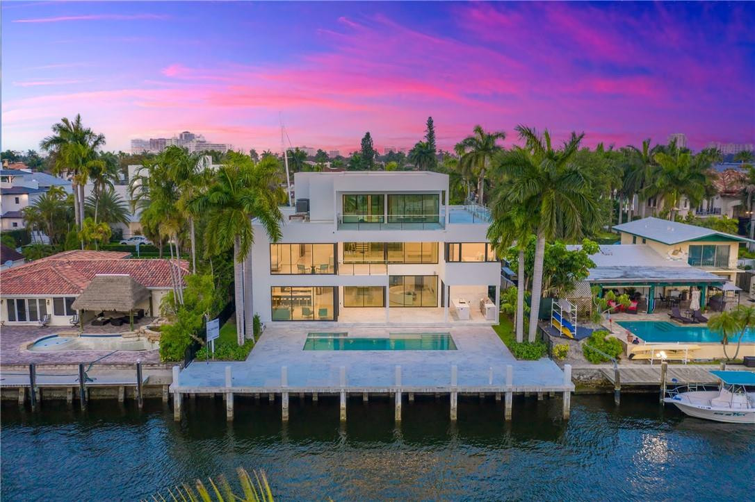 Beautiful brand new modern home in Las Olas! This three-story estate features stunning River views, White Thassos marble throughout, an eat-in kitchen,  all en-suite bedrooms, walk-in closets and an elevator. Master suite with water views, his & hers closets, dual vanities and steam shower. Perfect for entertaining with an open floor plan, third floor club room, beautiful backyard area and pool. 75' of water frontage with accommodation for up to a 65' boat and quick and easy ocean access. Also, a 6-car garage with lifts (3 bays presently). Located close to fine dining, shopping, and the FTL-Hollywood International airport!