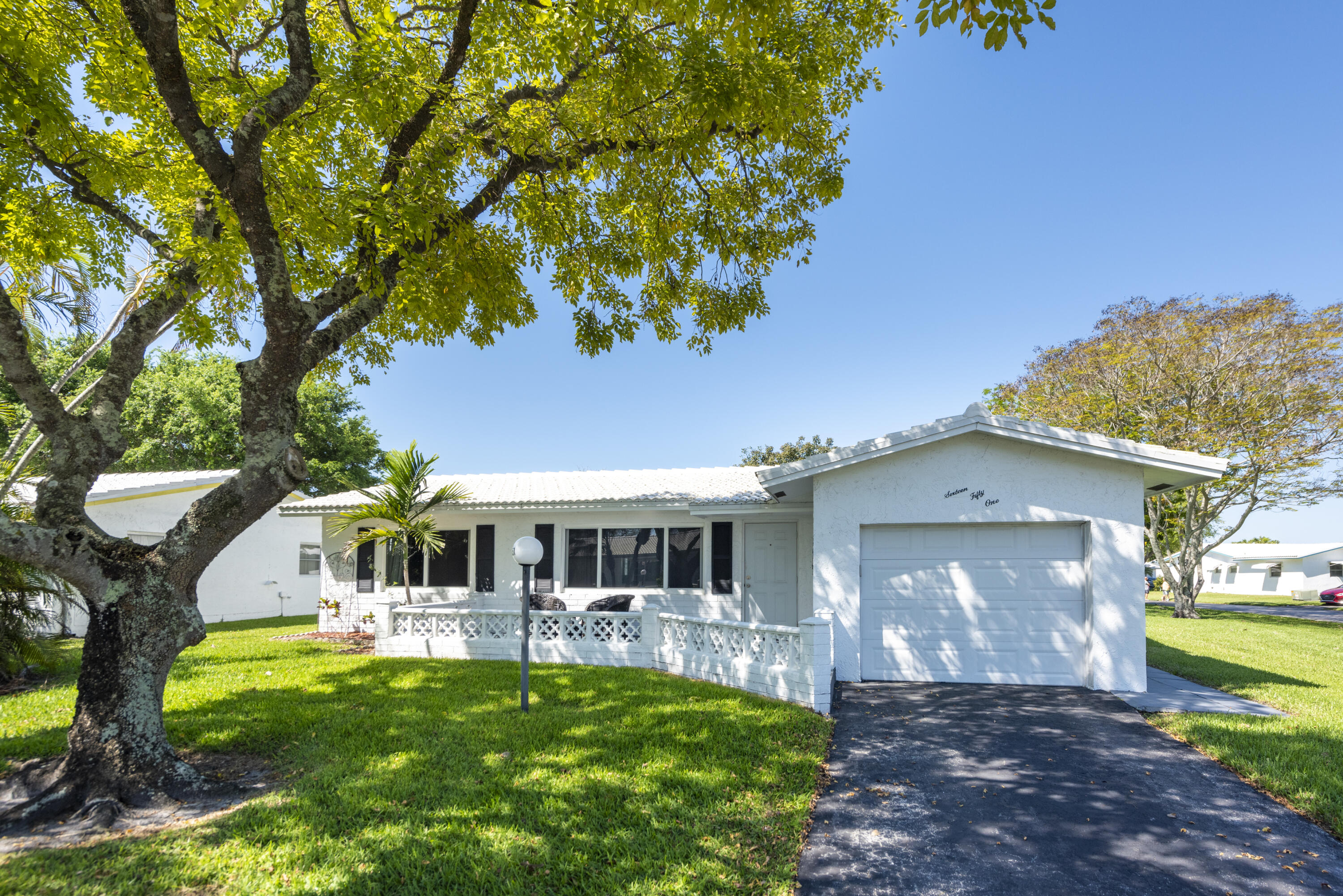 Laluderdale West two bedroom/two bath home on quiet street with lots of green space surrounding.  A/C 2020, UPDATED ELECTRICAL PANEL 2020, ROOF 2023, GARAGE DOOR MOTOR 2025,   HOA includes roof repair and replacement, pest control, lawn maintenance, courtesy shuttle bus, club house with pool, outdoor pool with spa, tennis courts, pickleball, library, wood shop and billiards. New impact glass and doors, recessed lighting in living areas and kitchen.