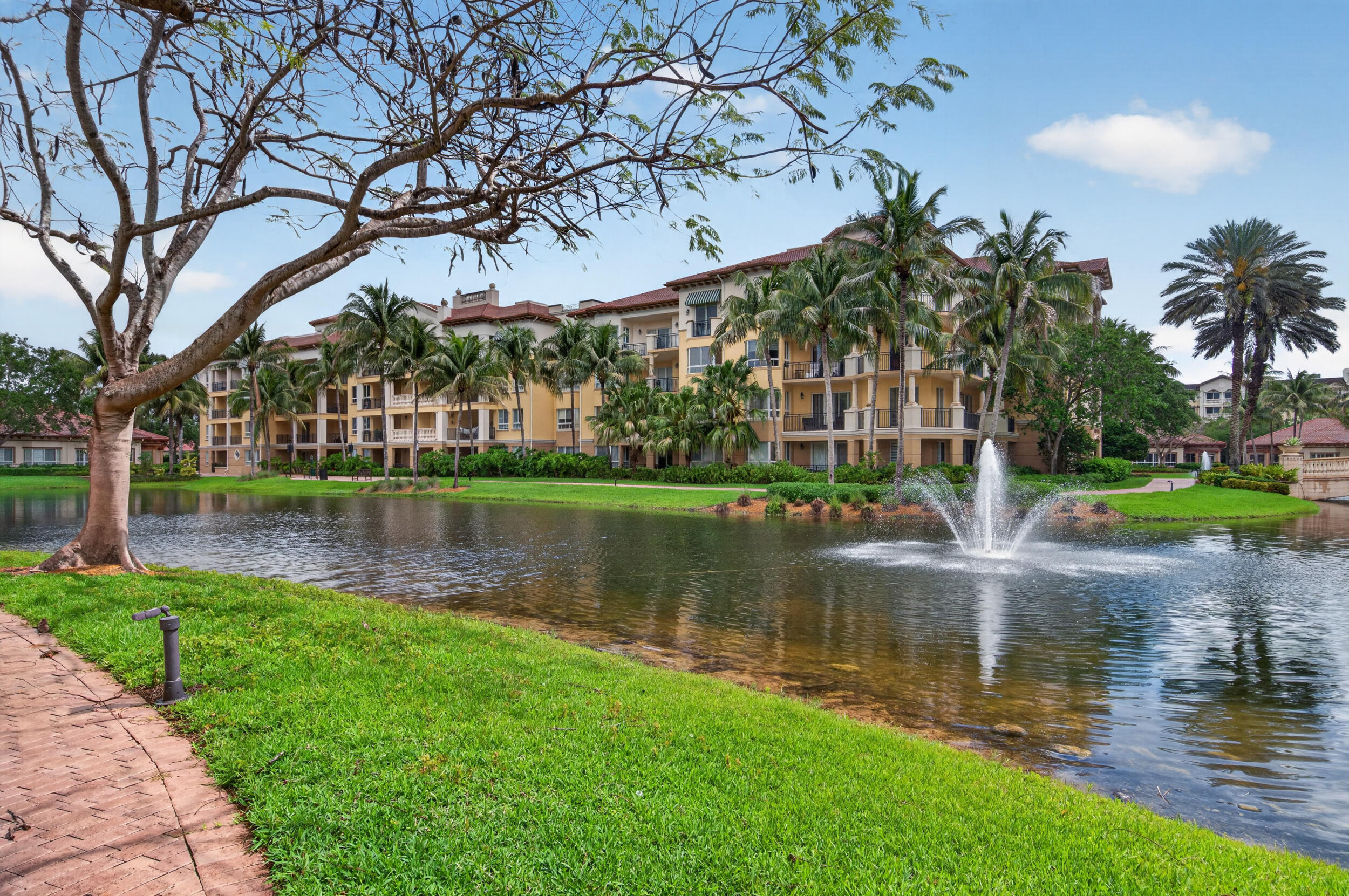 Stop looking...this unit has it all! Highly sought-after ground-floor residence with beautiful lake views and an expansive terrace with direct access to the community walking path. Tastefully renovated throughout, featuring stunning new bathrooms, custom closets, luxury laminate flooring, designer wallpaper, and elegant plantation shutters. Enjoy a secure lobby with valet parking, all within the prestigious Island House at The Palms at Weston—truly one of the best units available! Resort-style amenities complement an unbeatable location in Weston, within walking distance to supermarkets, pharmacies, and restaurants. Ammenities includes: pool, gym, social room, restaurant, concierge, card room, library and much more!  The Palms at Weston is a 55+ Condominium.