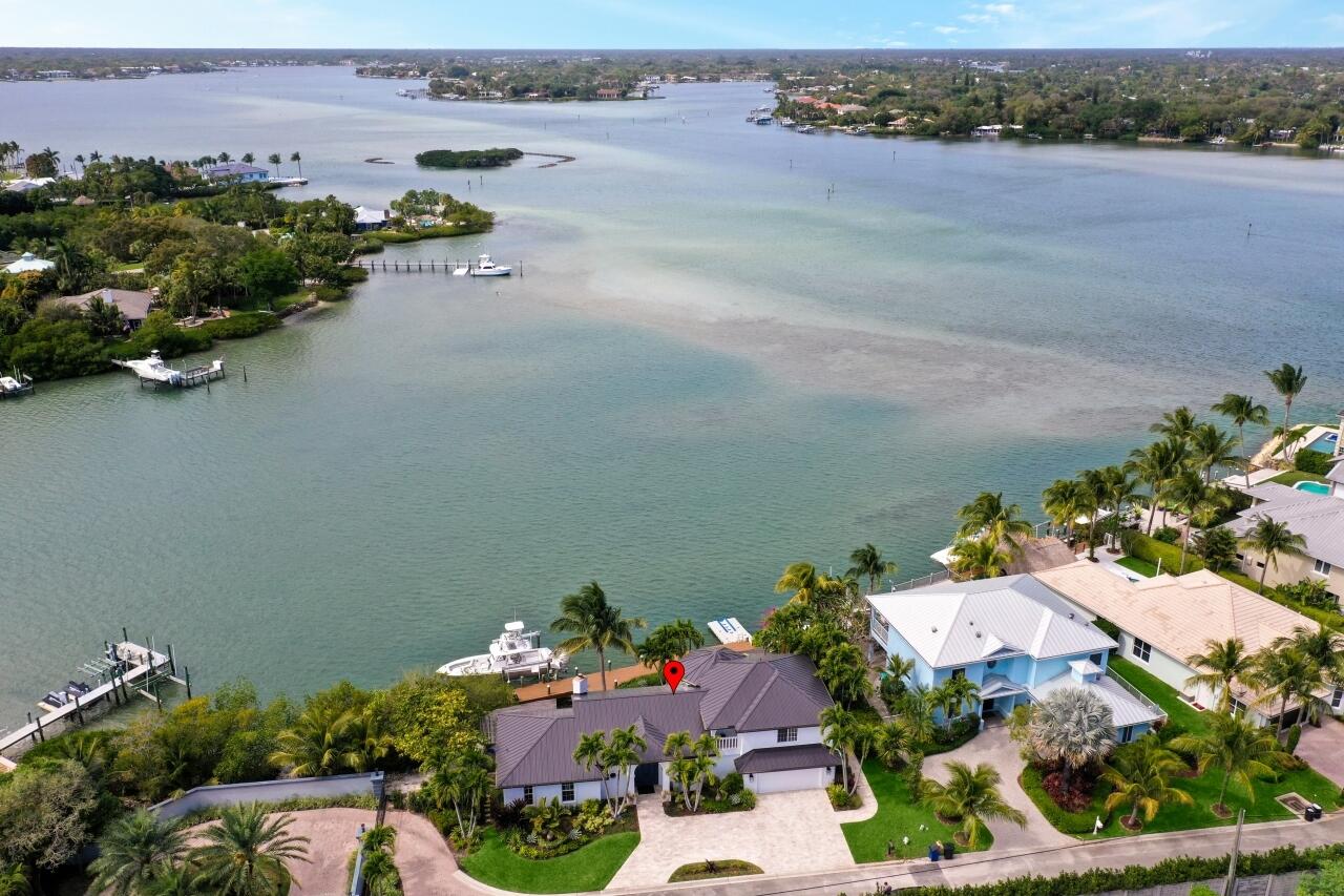 If you love the beautiful blue/teal/aqua colored breathtaking water, boating, paddle boarding, fishing in your backyard, watching the sunsets. or just being in the water, this property is for you. Welcome to paradise! This home is situated in an exclusive gated community consisting of only eight homes. When you enter the home, you will be greeted by breathtaking views of the Loxahatchee River. The Jupiter Inlet is just minutes away from this home, truly a boater's dream. Experience spectacular sunsets from your backyard as you take in the water views. Click the link under the main photo for the 3D Tour and videos.