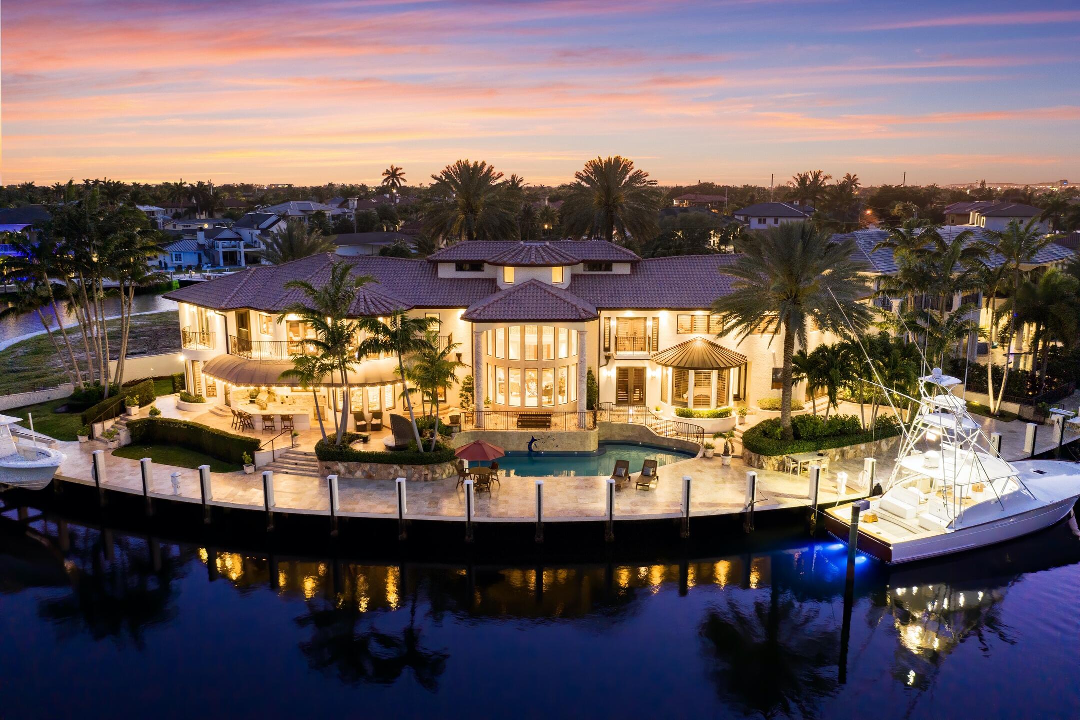 Exceptional gated estate tucked away on a quiet cul-de-sac offering ultimate privacy and waterfront living with 245 ft of deep water frontage. This one-of-a-kind custom home on an oversized lot offers 6 BR/6.5 BA with ample natural light, stunning great room atrium wall, impeccable design finishes and millwork. Complete with soaring ceilings, natural gas kitchen, state of the art home theater, library/billiards room, elevator, up and downstairs laundry, gym and sauna, and four bay garages. Expansive outdoor oasis with pool, summer kitchen and cabana bathroom built for entertaining, plus angler's room with direct access to the yacht dock. Located just minutes from Hillsboro Inlet and Atlantic Ocean.