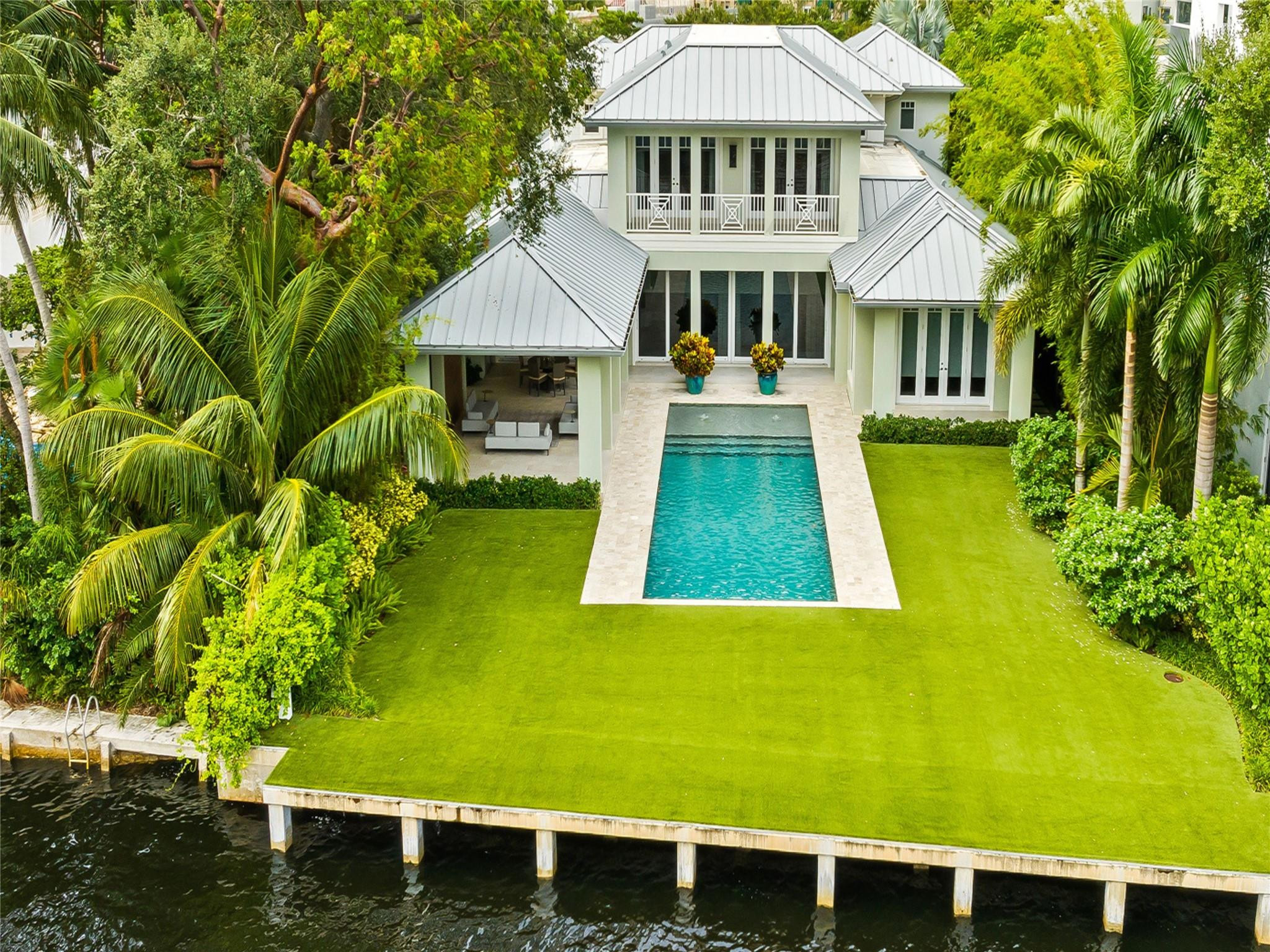 Experience the pinnacle of luxury waterfront in this exquisite 5BR|5.2BTH residence built by Bomar Builders. Nestled in a gated Las Olas neighborhood on prime waterfront with direct ocean access, it features a luxurious primary suite with a private office, perfect for work-from-home flexibility or a quiet retreat. The primary bath is a spa-like oasis with a separate shower, soaking tub, and double vanity. This property is designed for both relaxation and entertaining, featuring living areas with natural light and elegant finishes. The gourmet chef’s kitchen is equipped with top-of-the-line appliances, custom cabinetry and island, making it ideal for cooking and hosting. The seamless indoor-outdoor flow leads to a beautiful backyard with covered patio, outdoor kitchen and heated pool.