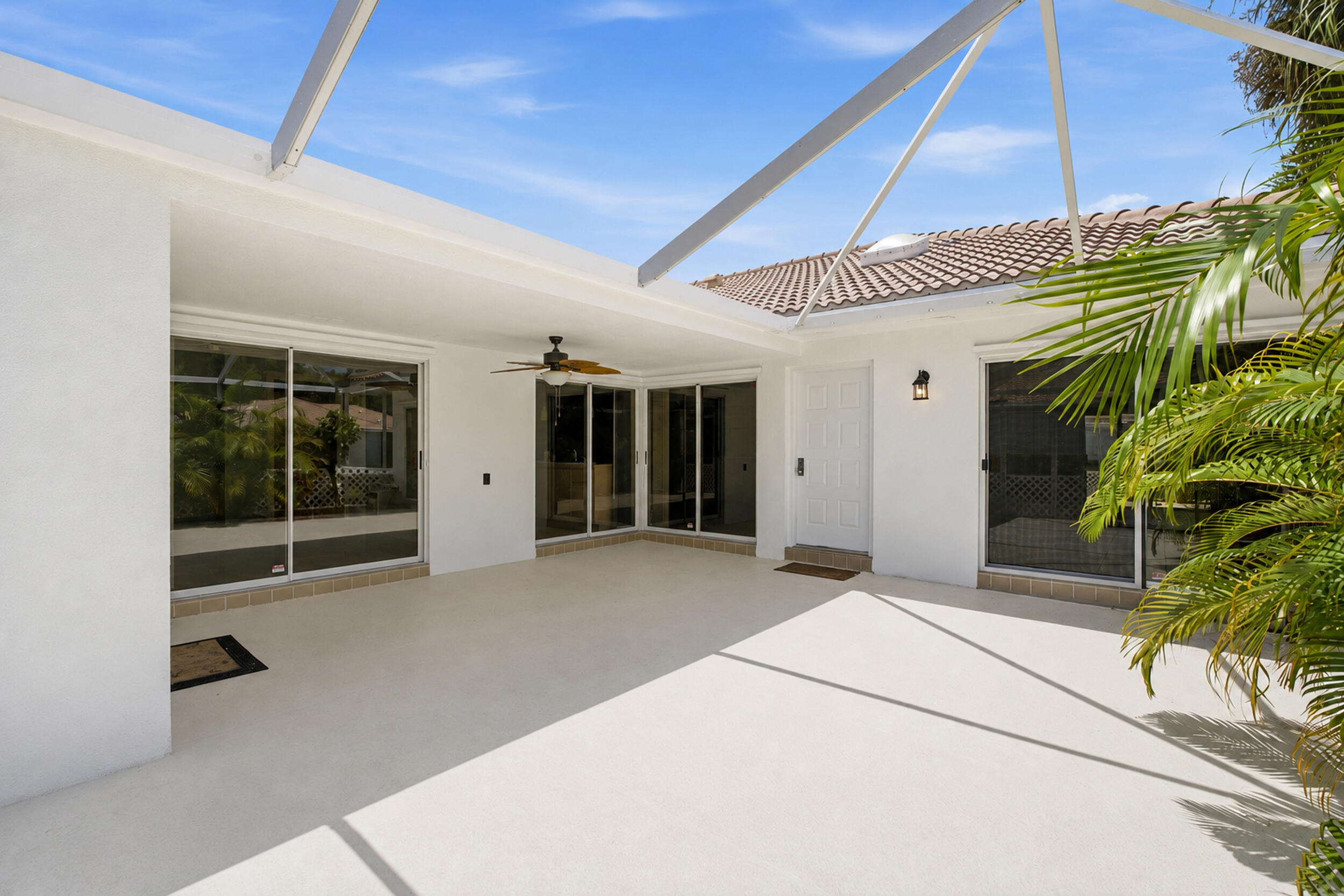 Welcome to Sun Terrace at The Oaks, one of Palm Beach Gardens' most desirable communities. Ideally located just minutes from The Gardens Mall, Downtown Palm Beach Gardens, dining, shopping, and entertainment, this well-maintained CBS villa offers the perfect blend of comfort and convenience. Ideally situated as a front unit just steps from your dedicated parking spaces, the home features an open kitchen with stainless steel appliances, tile flooring throughout, and custom closet cabinetry for exceptional storage. Major updates include a newer A/C and water heater, plus a washer and dryer just two years old. Complete hurricane protection provides added peace of mind. Enjoy Florida living on the covered, screened patio with a freshly repainted deck and an additional exterior storage closet.