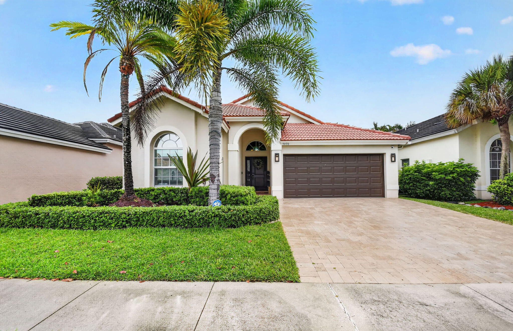 Discover this beautifully updated 3-bedroom, 2-bath lakefront home in the desirable Lake Charleston community. Designed for both comfort and style, the home features soaring ceilings, an open-concept layout, abundant natural light, updated tile flooring, recessed lighting, and custom window coverings. The modern kitchen offers quartz countertops, white cabinetry, a marble backsplash, KitchenAid stainless steel appliances, and a large breakfast bar. The spacious primary suite includes a custom walk-in closet, patio access, and a luxurious updated bath. Step outside to a screened-in pool overlooking the lake and a fully fenced backyard.  Additional highlights include full impact windows and doors for maximum storm protection, a brand-new AC, sprinkler, whole-house generator, and a travertine driveway. Enjoy access to community pools, parks, sports courts, playgrounds, and top-rated schools nearby.