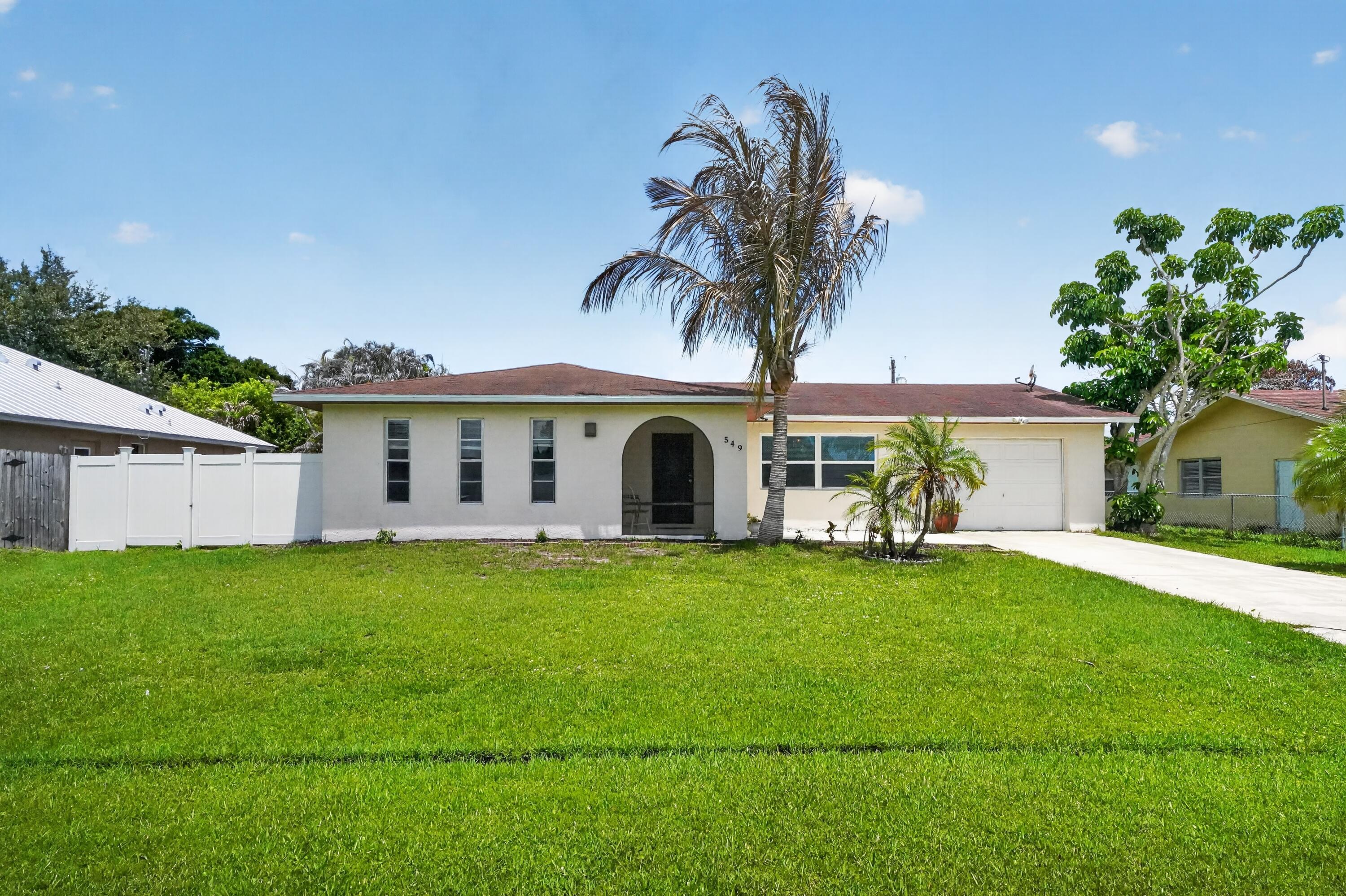 Welcome to 549 SE Marydale Terrace in beautiful Port St. Lucie! This charming 2-bedroom, 2-bath home with an additional 11x17 bonus room that could be used as a third bedroom, flex room, or office. 1,406 sq. ft. of comfortable living space with a bright open layout and a split-bedroom floor plan for added privacy. The spacious primary suite provides a relaxing retreat, while the oversized 10,000 sq. ft. fenced yard offers endless possibilities for entertaining, gardening, or creating your dream backyard oasis. Whether you're searching for your forever home, a seasonal getaway, or a smart investment opportunity, 549 SE Marydale Terrace is full of potential and ready for its next chapter. Schedule your private showing today and experience everything this Port St. Lucie gem has to offer.