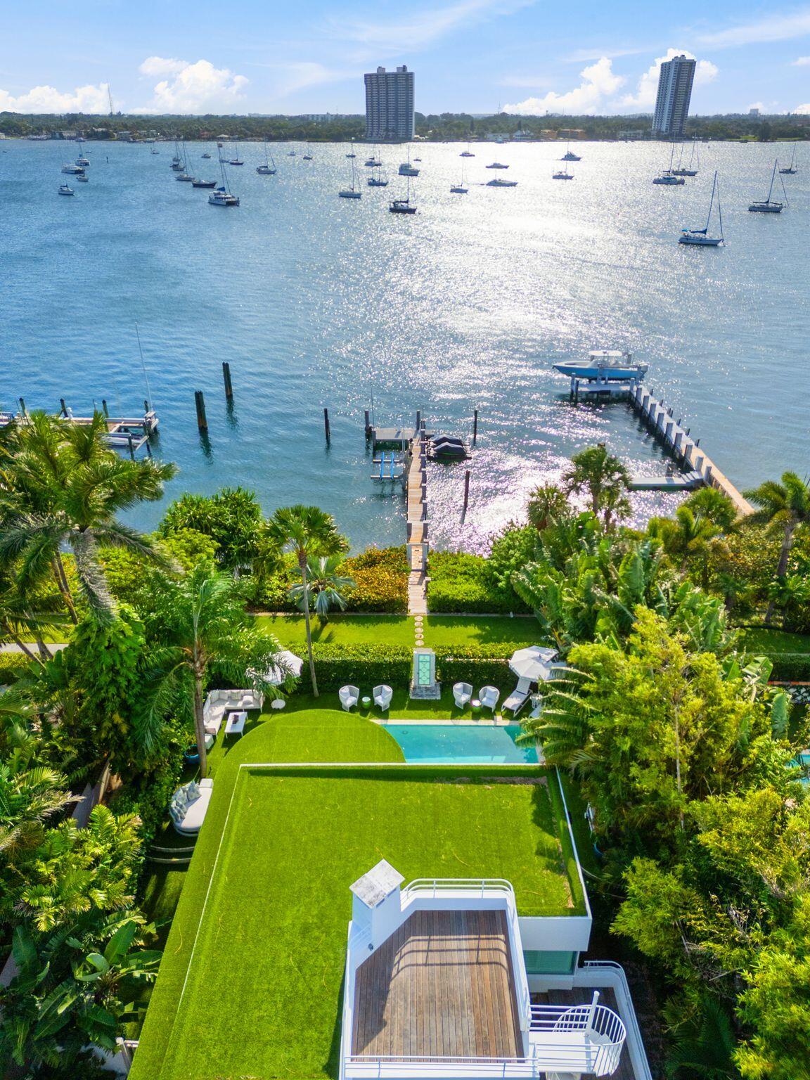 A beautifully renovated, masterful landmark of Modernist architecture, the Boat House combines the very best elements of life in Palm Beach - the perfect spot on the lakefront with dock and boat-lift, deeded ocean access at the Mockingbird neighborhood beach cabana, and an incredibly elegant, exquisitely renovated, move-in ready home. This nautically themed Art Moderne home faces prow-forward toward dramatic sunsets, its rooftop deck overlooking the pool, dock and sparkling Intracoastal. Sea-going touches include seamed hardwood floors, porthole windows and white-piped terrace railings. The house received a full renovation a few years ago and the current owners then made meaningful improvements of their own. Those improvements include all new AC units including one for the garage, a high-end water filtration system, an oversized wine and beverage fridge, a smart home tech center and electric awning for the dining terrace. And to top it all off- an outdoor infrared sauna!
Mockingbird is one of the very few Palm Beach streets with both  a private neighborhood beach cabanas and direct lake trail access.
(video available)