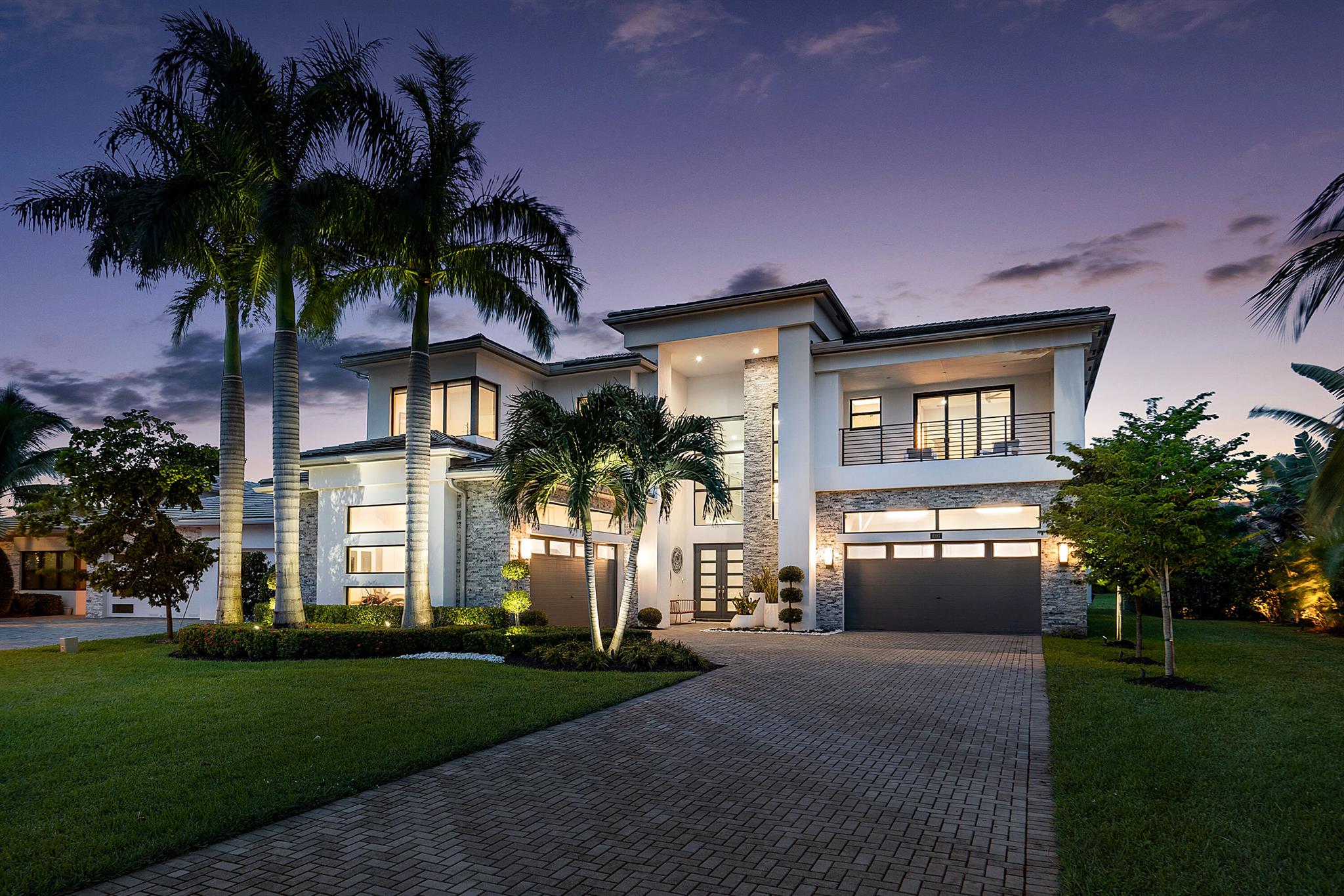 Step into an unparalleled custom contemporary estate in Boca Bridges, where modern elegance meets meticulous design by the renowned Mancini Duffy firm. Every inch of this exquisite home has been thoughtfully curated, featuring luxury finishes imported from Italy and Spain that add depth and sophistication to each space. The grand entrance reveals a sweeping open-concept layout adorned with a custom glass staircase, elegant CavaStone porcelain floors, and striking Sonneman chandeliers that set the tone for this exceptional residence.

In the heart of the home, the family room centers around a sleek linear fireplace, effortlessly flowing into the kitchen and dining areas. Natural light fills the space, illuminating the custom Pedini kitchen outfitted with premium Miele integrated appliances, a stunning porcelain-layered island, and Dorn Bracht fixtures. Additional contemporary touchesincluding a custom leather wall unit, drop ceiling details, and bold geometric lightingbring warmth and style to every corner.