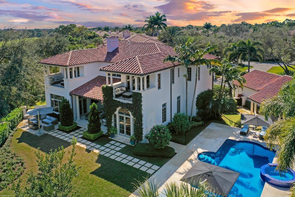 This spectacular light and bright estate home offers a spacious floor plan located in the prestigious Trump National. The estate offers a separate 2bd/2.5 bath guest house with living room, laundry, and preserve views. This custom built home boasts 7 bedrooms and 7 1/2 bathrooms, along with a 4 car split garage with one space being air conditioned. Walk in the welcoming entryway leading to a light and bright sitting room with fireplace and backyard views. The family room has stunning custom built-ins for the perfect entertaining space. The crisp white eat-in kitchen offers top of the line appliances, including Sub-Zero refrigerator and gas range. Enjoy your morning coffee with beautiful views of the lush greenery from the large kitchen bay window. Stay in and enjoy movie nights in the well appointed home theater, featuring comfortable leather chairs and oversized media screen. Retreat to your luxourius primary bedroom suite with newly refinished wood flooring and custom fitted closets. Step outside your bedroom and relax on the private balcony and enjoy the views. The primary ensuite offers dual vanities with new porcelain countertops, jacuzzi tub, and large glass walk-in shower. The den/office offers custom built-ins and double french doors bringing plenty of natural light to the space. Step outside to your own private retreat. The beautiful backyard offers a sparkling custom pool/spa featuring new tile and coping. Relax under your covered patio, or move to the newly designed sitting area under a custom built pergola. New electric screens have been installed off of the living room and breakfast room. Gather around the outdoor fire pit on chilly evenings.  This property boasts the largest lot on the street and also offers a long winding driveway. The estate is also well equipped with a whole house generator. The property is beautifully landscaped and offers accented outdoor lighting.