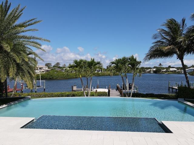 Gorgeous water view with private boat lift. Great location close to the front entrance and main clubhouse.  Victory is a non-thru street.  Roof and appliances were replaced in 2013. Covered Loggia to enjoy the sunsets and incredible wildlife. SWAT mosquito system has been installed.  Outdoor living at it's best with an outdoor grill, pool, fire pit, cabana bath, IPE dock and covered loggia. Kitchen has been refreshed with countertops and backsplash. Huge shower in the master bathroom with double sinks and tons of storage space. Water view from the master bedroom, living room and 2nd bedroom which makes for a gorgeous office space.
Porcelain floors, skylights and vaulted ceilings complete this home.  Admirals Cove is a Platinum level full service club including 6 restaurants, marina, tennis, pickleball, kids club and summer camp. 30 Room boutique hotel, new salon and spa, fitness center and card rooms.