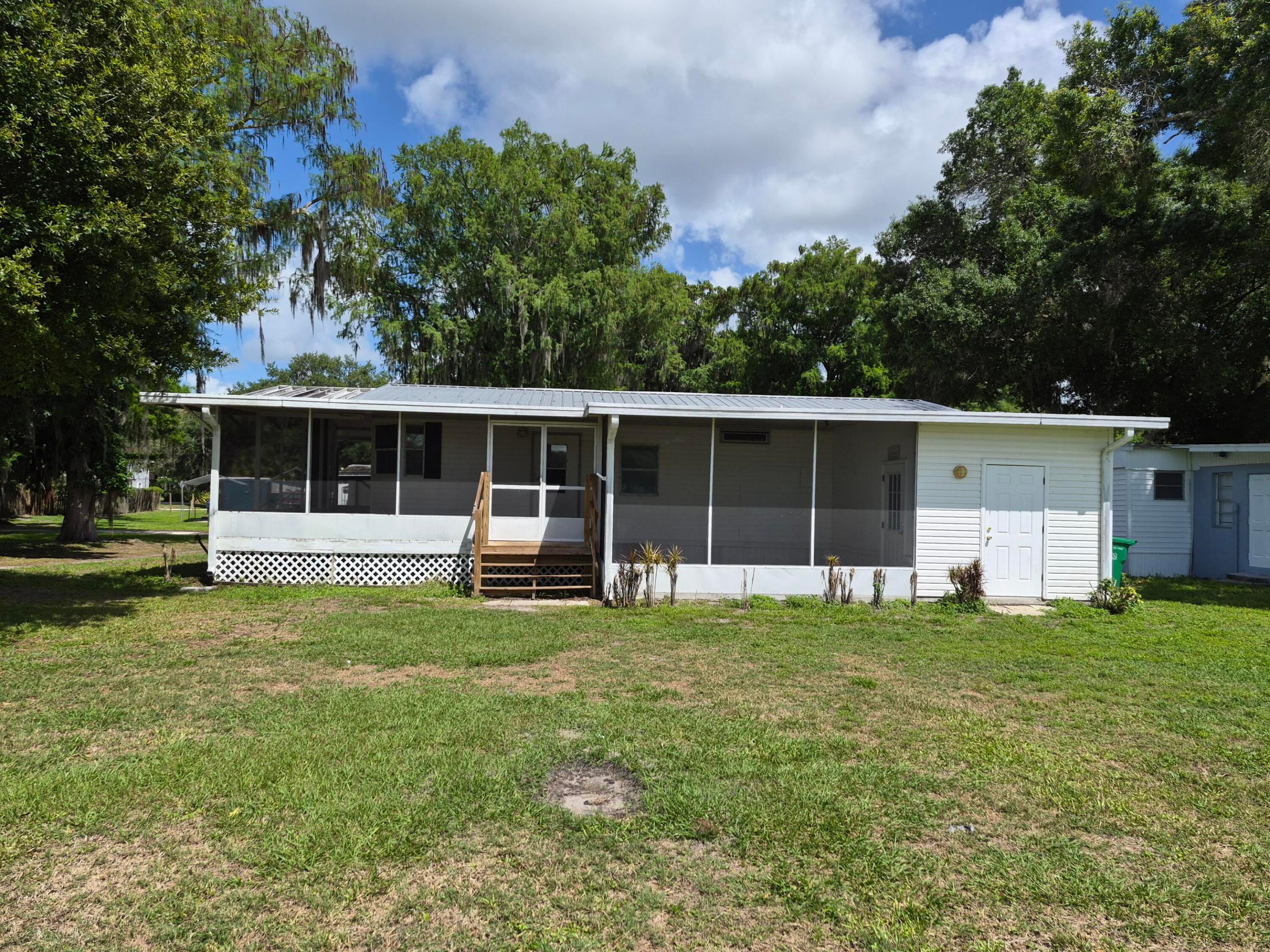 Updated 2BR/2BA double-wide mobile home in the heart of Okeechobee—just steps from access to Lake! Located less than 200 feet from the boat ramp, this property is ideal for fishing enthusiasts and outdoor lovers. This well-maintained home features a functional layout with comfortable living spaces and recent updates. The spacious screened-in porch includes an additional room with air conditioning and electric already in place—ready for your finishing touches to create a home office, guest space, or bonus room. A shed in the backyard provides extra storage, and the property is conveniently located near shopping, dining, and local amenities. Perfect as a full-time residence, weekend retreat, or investment opportunity. Schedule your showing today!