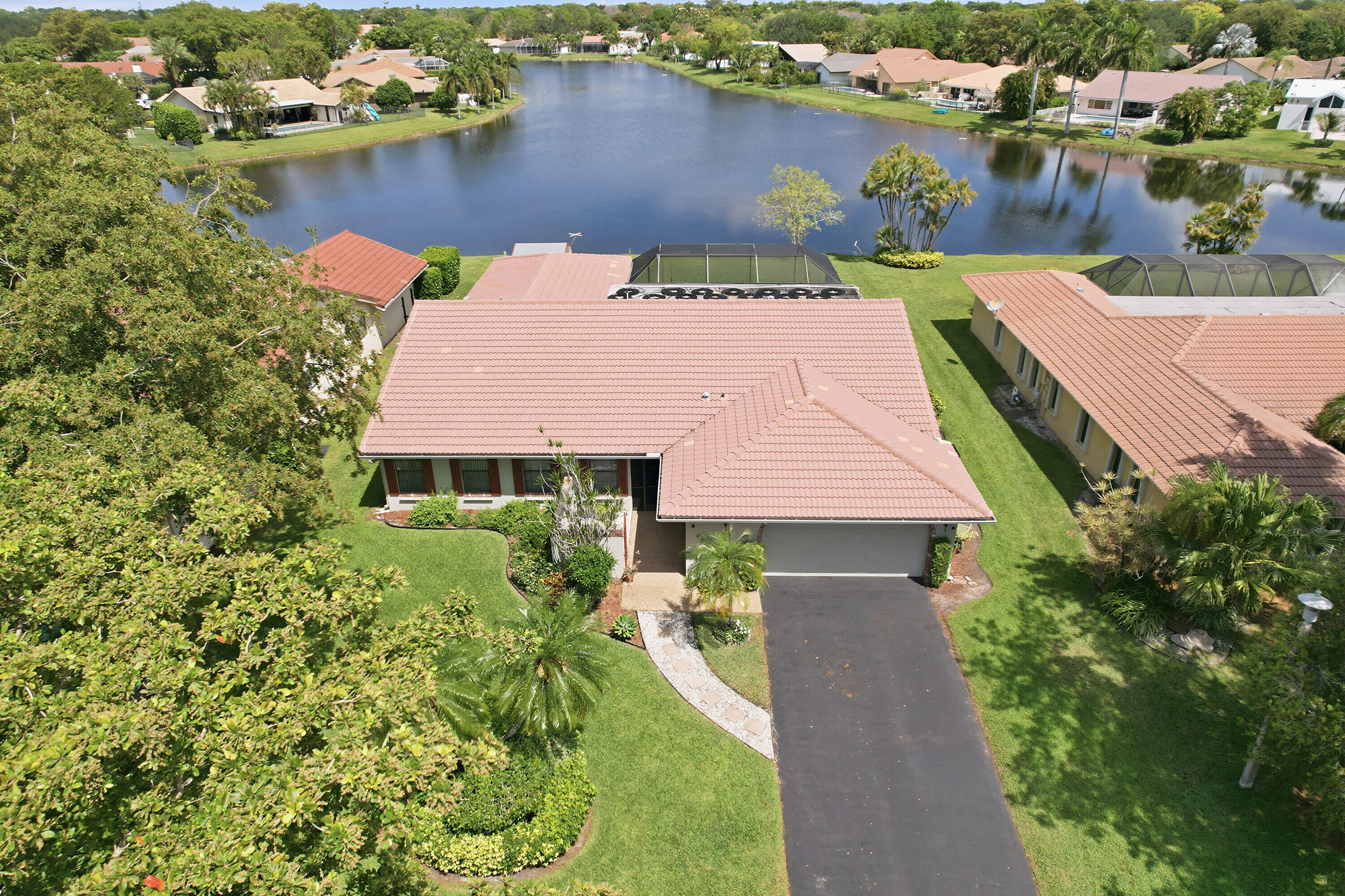 Pack your bags—this expanded Patrician model in highly sought after Cypress Lakes may be the last move, you'll ever want to make. OWNERS PUTTING A BRAND NEW $55,000 ROOF, with a 15-year transferable warranty!  Stunning 4bedroom - 2-bathroom waterfront home with over 500 ft of serene water views. Features include a new 2023 A/C, gorgeous upgraded open kitchen concept with Stainless appliances & granite, split floor plan, 2 and a half car garage, and a permitted storage shed for exceptional extra space. Enjoy complete hurricane protection for your discounted insurance as well as your safety.  Enjoy top rated Coral Springs schools and peaceful living in a prime location. This view like no other house has at this price point.  Roof will be completed before closing!