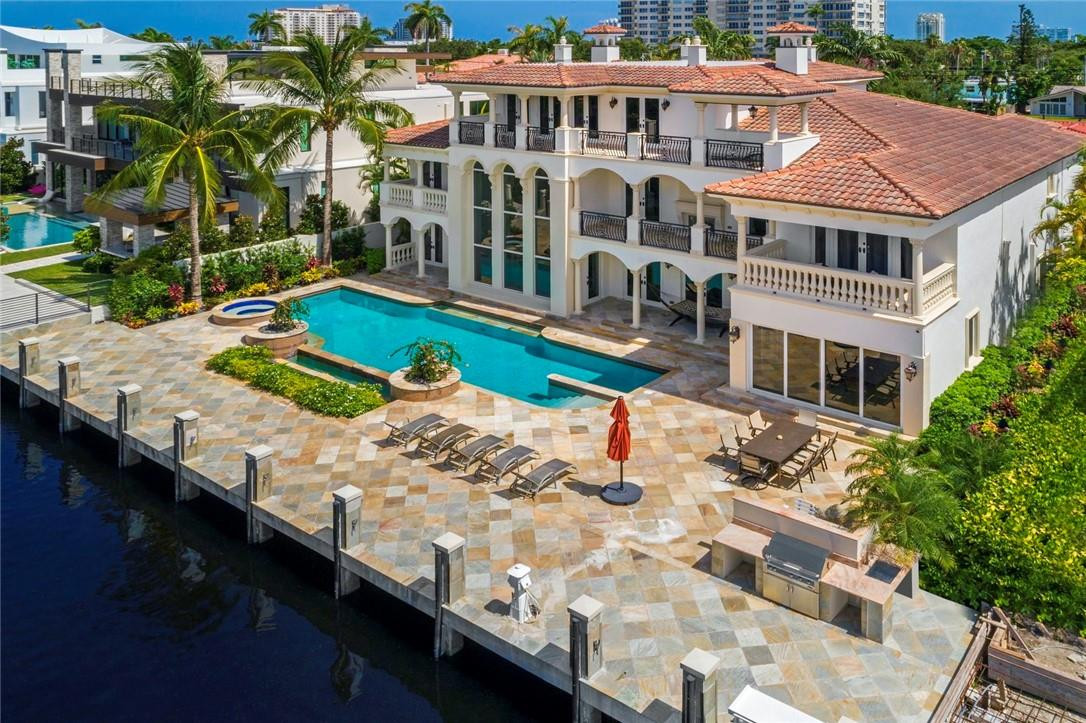 Most elegant waterfront estate in posh Las Olas neighborhood of 7 Isles. Large flowing floor plan, 8700 sq ft, 6 bedrooms, 7 baths, wood paneled office, 2nd floor lounge, 3rd floor billiard, media room, bar. Major remodel, new a/c, impeccably cared for by original owners in like-new condition. New concrete seawall & dock at high elevation flush with pool deck, 55’ pool, lap lane, new pool surface. Pool deck is unique beautiful Brazilian quartz. High quality granite, marble, quartz installed by Europe craftsmen. Bar area connects chef’s kitchen, formal dining room & two-story living room with gas fireplace. Master suite sitting, exercise room, two large closets, separate toilettes, dual sinks/vanities, onyx countertops, jacuzzi, separate shower. Pet room, walking distance to downtown, beach