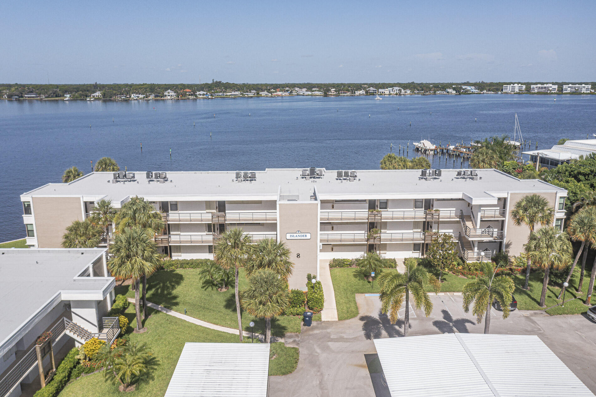 Enjoy year-round coastal living in this exceptional 2-bedroom, 2-bathroom waterfront residence positioned directly along the wide waters of the St. Lucie River. Located in Stuart's premier active adult community, Circle Bay Yacht Club, this unit perfectly blends comfort, tranquility, and a boater's lifestyle. Wake up to serene water views from the master suite and unwind on your patio watching boats glide past on the river. If you own a watercraft, take advantage of the ultra-affordable community slips ($2.00/ft/month) providing quick, bridge-free ocean access. Residents enjoy premium community amenities including a large heated salt water pool, gas grilling stations, a boardwalk over the water, and an active clubhouse with a library and billiards room. HOA includes water, sewer, trash