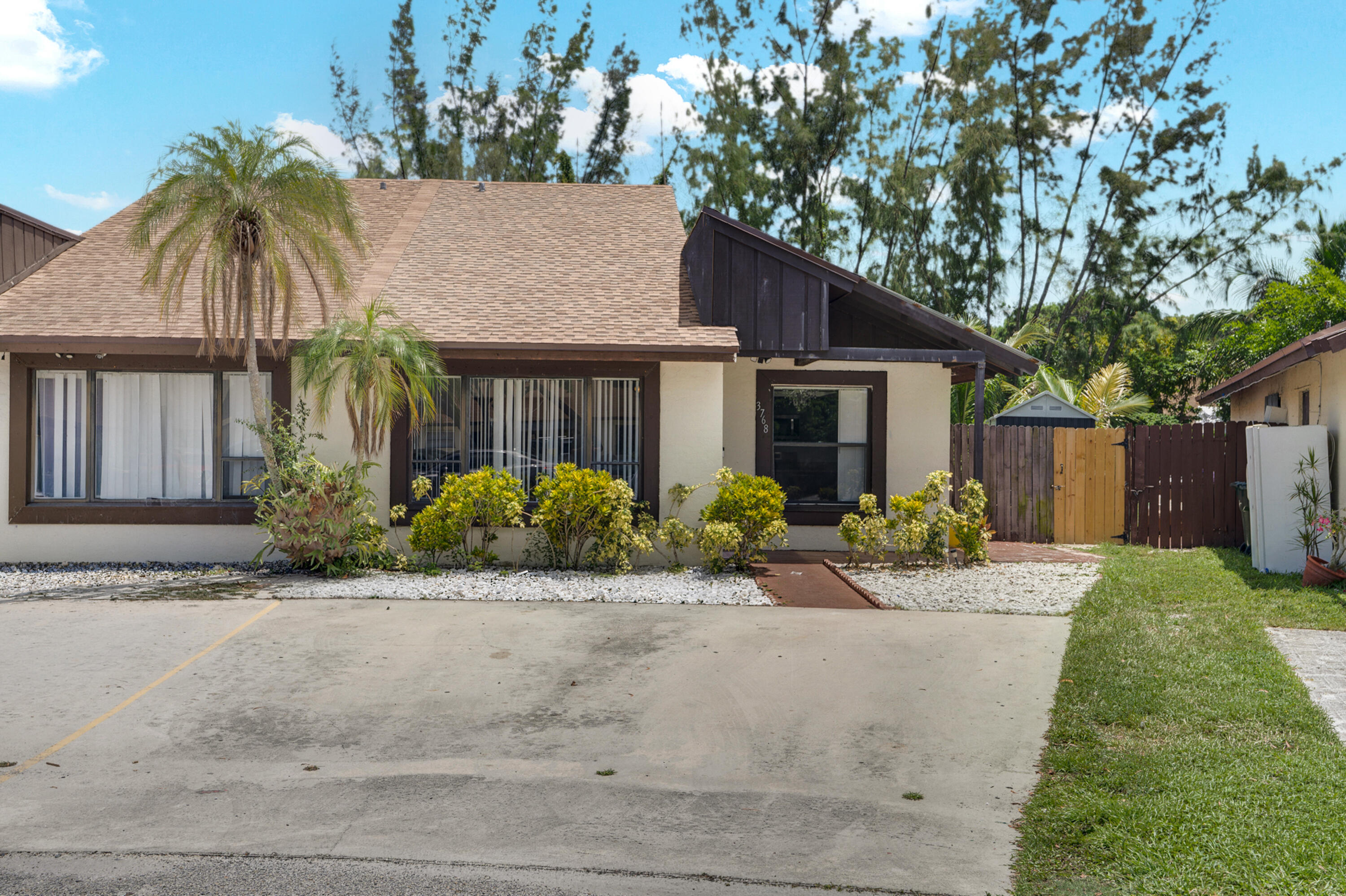 Discover this inviting 3-bed, 2-bath villa with a fenced backyard, perfect for first-time buyers. The kitchen showcases granite countertops, sleek gray cabinetry, stainless steel appliances, and there's a washer and dryer included. The living area is comfortable and great for hosting. Both bathrooms offer modern vanities. With a 2026 roof, two front parking spaces, and a prime cul-de-sac location, you're close to schools, dining, I-95, the Turnpike, and all West Palm Beach amenities.