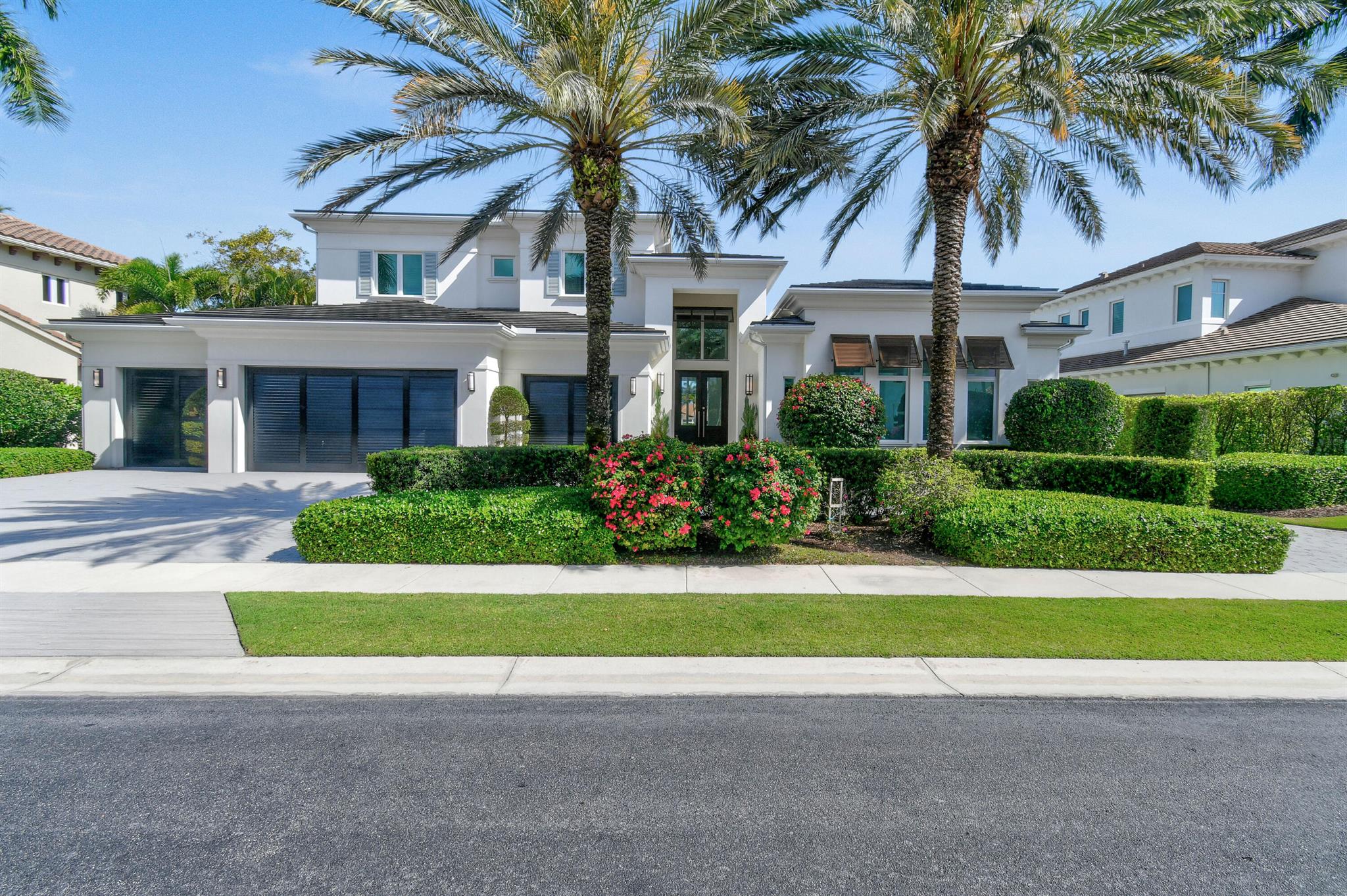 Welcome to 687 Hermitage Circle—an exceptional custom modern estate residence built in 2016 by award-winning Bloomfield Construction, located in the exclusive Hermitage section of Frenchman's Reserve. This highly coveted Barbados model offers 4 bedrooms, 4.5 baths, a ground-floor clubroom/office, and an oversized four-bay air-conditioned garage. Every element reflects timeless sophistication, complemented by sweeping lake and fairway views. Designed for effortless indoor-outdoor living, the home features expansive, sunlit interiors with honed limestone and rich hardwood flooring, luxury fixtures, and open-concept gathering spaces. The chef's kitchen is a true centerpiece, showcasing Cristallo Quartzite countertops, Sub-Zero refrigeration, a Wolf gas range, a Thermador microwave drawer, and a large island perfect for entertaining.

The first-floor owner's suite is a peaceful retreat with a sitting area, oversized custom closets, and a spa-style bath featuring dual vanities, a soaking tub, and a rain shower. The ground-floor clubroom/office is finished with custom built-ins, a wet bar, and a mini fridge, offering flexible space for work or entertaining. Upstairs, three ensuite guest bedrooms provide privacy and comfort for family and visitors, while a powder room on the main level serves guests. Outside, the private backyard is built for entertaining, offering a covered loggia, a fully equipped summer kitchen, a heated saltwater pool, a raised spa with a waterfall feature, and lush tropical landscaping.

Beyond the home, Frenchman's Reserve delivers a resort-caliber lifestyle with an Arnold Palmer Signature Golf Course, seven HydroGrid clay tennis courts, a resort-style pool, a full-service spa and salon, a state-of-the-art fitness center, and a grand clubhouse with multiple dining venues and a vibrant calendar of social events. With the advantage of a Full Golf Membership, 687 Hermitage Circle offers not only an exceptional custom home but the complete experience of luxury country club livingjust minutes from the best beaches, shopping, and dining in Palm Beach Gardens.
