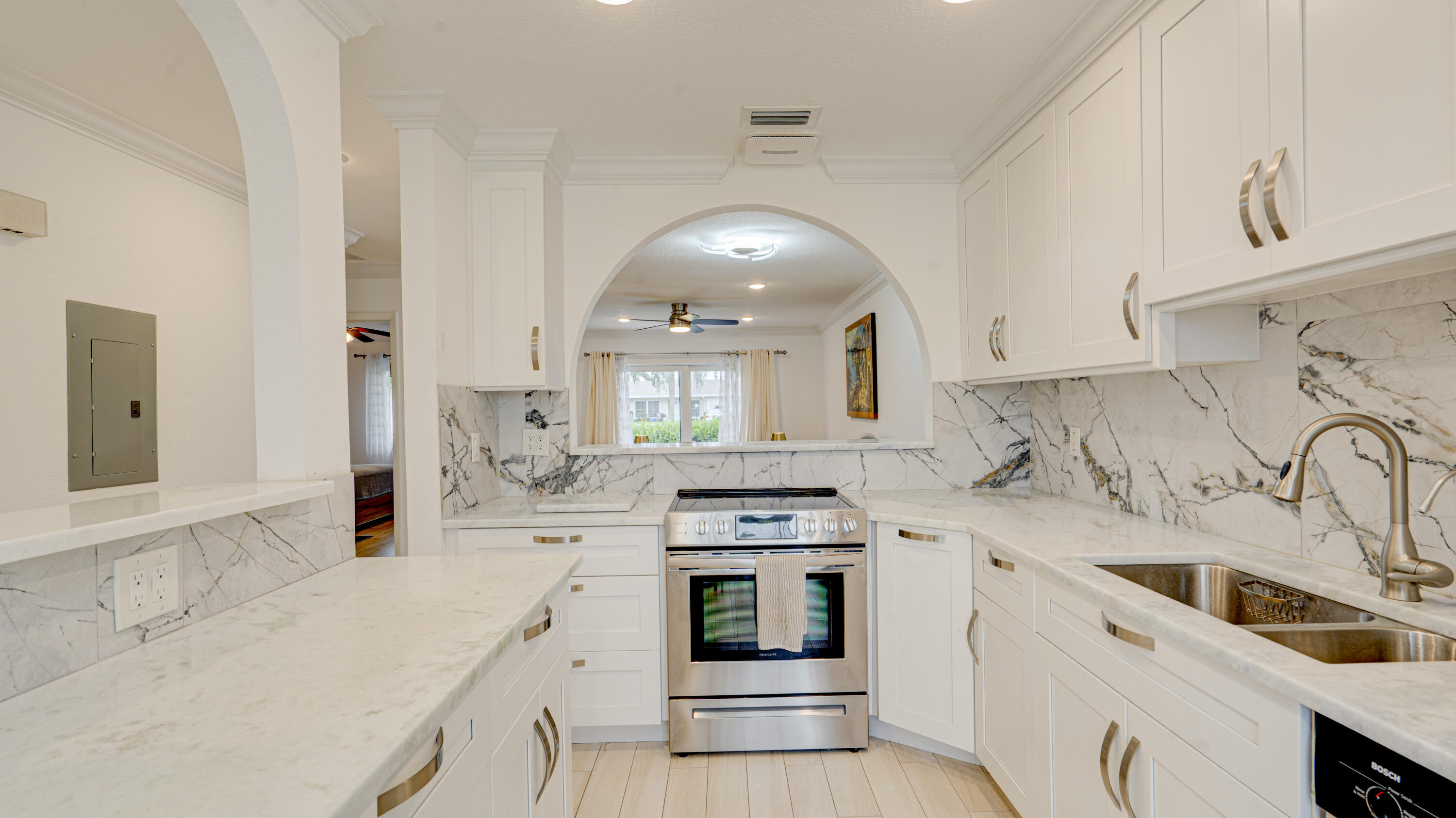 Beautifully remodeled 2BR/1BA villa in the gated 55+community of Boca Lakes. Move-in-ready with an updated kitchen and bath with granite countertops, stainless steel appliances, porcelain tile flooring, & crown molding throughout. Recent upgrades include new A/C & ductwork, hurricane-impact windows/doors, updated electrical panel, tankless water heater, in-unit washer and dryer, and a newer roof and insulation. Assigned parking directly in front with plenty of guest parking. HOA includes cable, internet, water, sewer, roof maintenance, and landscaping. Enjoy lush tropical surroundings and resort-style amenities, including a clubhouse, pool, sauna, tennis, bocce, shuffleboard, and social activities. Conveniently located near major highways, shopping, restaurants, Boca Mall, and the library