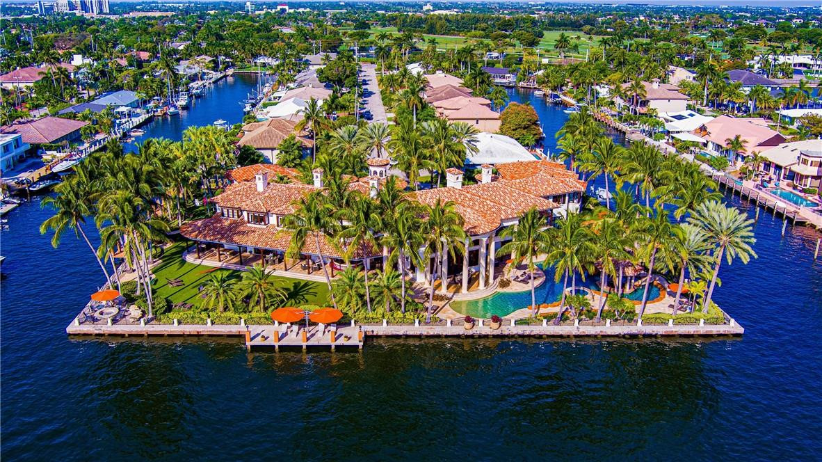 Gated Palatial Palm Beach-Inspired Point Estate sited in the prestigious Coral Ridge Country Club enclave on over 1.09 acre +/- framed by 3 sides of wrap-around water frontage totaling 665 ft +/- with 200 AMP, 3 Phase, 480 Volt mega-yacht service. Amenity-rich trophy mansion offered furnished, artfully designed by architect William Storrs, & crafted by WA Bentz with the finest materials & finishes, boasting nearly 24,000 sq ft +/- capturing stunning water views from every major room, including a separate carriage/guest house. Modern smart-house with fingertip control for all systems; whole-house generator, commercial elevator & 102 ft +/- long waterside resort-style pool. Wellness wing with gym, spa, salon, solarium, media & game room, library, staff quarters & impressive 7 bay garage. DISCLAIMER: Information published or otherwise provided by the listing company and its representatives including but not limited to prices, measurements, square footages, lot sizes, calculations, statistics, and videos are deemed reliable but are not guaranteed and are subject to errors, omissions or changes without notice. All such information should be independently verified by any prospective purchaser or seller. Parties should perform their own due diligence to verify such information prior to a sale or listing. Listing company expressly disclaims any warranty or representation regarding such information. Prices published are either list price, sold price, and/or last asking price. The listing company participates in the Multiple Listing Service and IDX. The properties published as listed and sold are not necessarily exclusive to listing company and may be listed or have sold with other members of the Multiple Listing Service. Transactions where listing company represented both buyers and sellers are calculated as two sales. “No payments made until title passes” Some affiliations may not be applicable to certain geographic areas. If your property is currently listed with another broker, please disregard any solicitation for services. Information published or otherwise provided by seller, listing company or its representatives is deemed reliable but are not guaranteed and subject to errors, omissions, or changes without notice. Copyright 2025 by the listing company. All Rights Reserved.