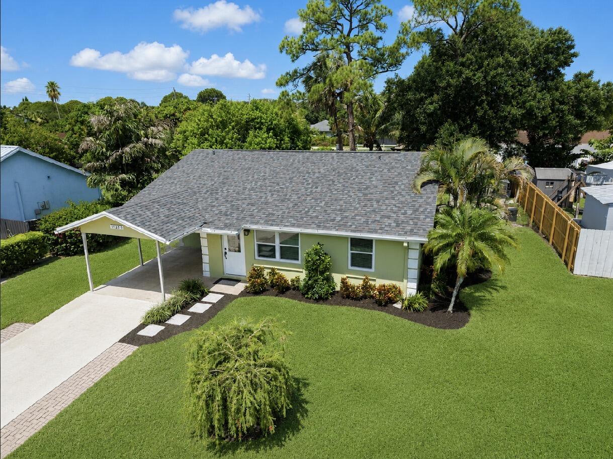 Welcome to this beautifully maintained CBS construction home offering 1,494 total square feet and the pride of one-owner ownership. This move-in-ready property has been meticulously cared for and features a brand-new roof (2026), new A/C (2026), and impact windows for added peace of mind and energy efficiency. Inside, you'll find an updated interior with a desirable split floor plan, a separate laundry room, and an abundance of storage throughout. The home also includes a convenient carport and an additional storage shed in the backyard. Step outside to a beautifully landscaped backyard featuring a spacious patio, lush green space, and meticulously manicured grounds perfect for relaxing, entertaining, or enjoying Florida's outdoor lifestyle. Ideally located just minutes from the beach and only minutes from shopping, fine dining, casual restaurants, entertainment, and everyday conveniences. Families will also appreciate the proximity to A-rated schools. This exceptional home combines quality construction, thoughtful updates, and an unbeatable location. Don't miss the opportunity to make it yours!