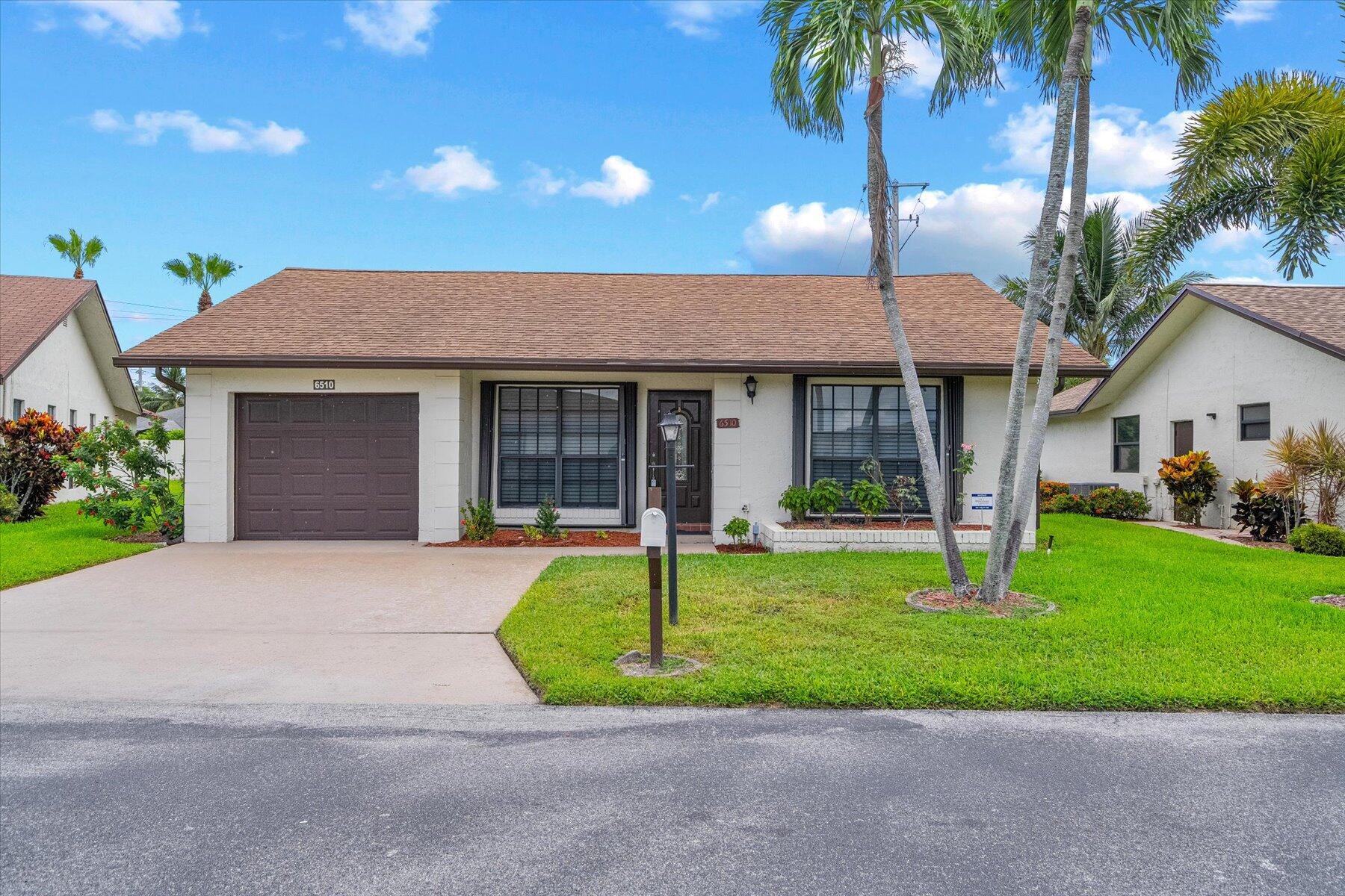 Welcome to your peaceful retreat in a vibrant 55+ community! This beautifully maintained 2-bedroom, 2-bath single-family home features a remodeled kitchen, newer appliances (approximately 1 year old), accordion hurricane shutters, and a private backyard enclosed with lush clusias for added privacy. Bright and inviting living spaces flow seamlessly to a relaxing patio perfect for outdoor enjoyment. The home also includes a 1-car garage plus a 2-car driveway. The HOA includes internet, cable, alarm service, and maintenance of common areas for added convenience and peace of mind. Residents enjoy resort-style amenities including a pool, jacuzzi, fitness center, tennis, shuffleboard, bocce courts, billiards, library, barbecue area, and an active social atmosphere. Centrally located near shopping, dining, and entertainment, this home offers the perfect blend of comfort, convenience, and community living.