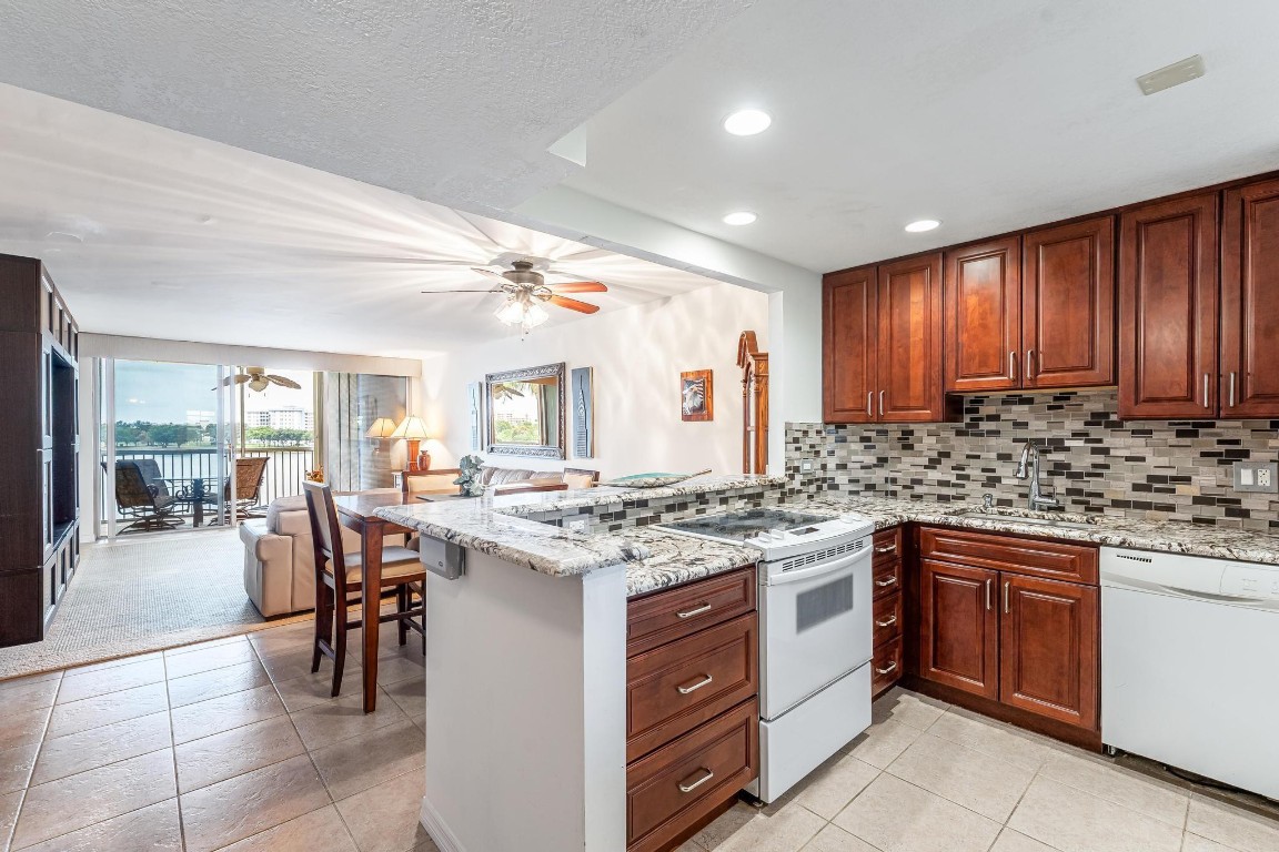 EXPERIENCE EPIC VIEWS from this Gorgeous Updated Lakefront Condo on Tranquil North Course in Palm Aire. Foyer Leads to Open Kitchen w/Ice-White Appliance Suite, Glass Tile Backsplash, Recessed Lights, Granite Counters & Coffee Bar, Rich Maple Cabinetry. Spacious Great Room Segues to Stunning Private Screened Balcony w/Extra Storage. Tile T/O Except Front Bedroom has Carpet. Double Suites w/Plentiful Closet Space & Ensuite Baths w/Frameless Glass Doors. Lakeside Rear Bedroom w/French Door Entry. Laundry Just Steps From Your Entry. Enjoy all the Perks! Walk to Resort Pool. Near Golf, Publix, Park, Tennis, Harrah's, TopGolf, Dining, Shops. Short Drive to Beach & Airport. Secure HOA. Reserves Funded, 50 Yr. Inspections Completed, No Special Assessments. Wi-fi & Cable Incl. All-Ages. 2 Cats.