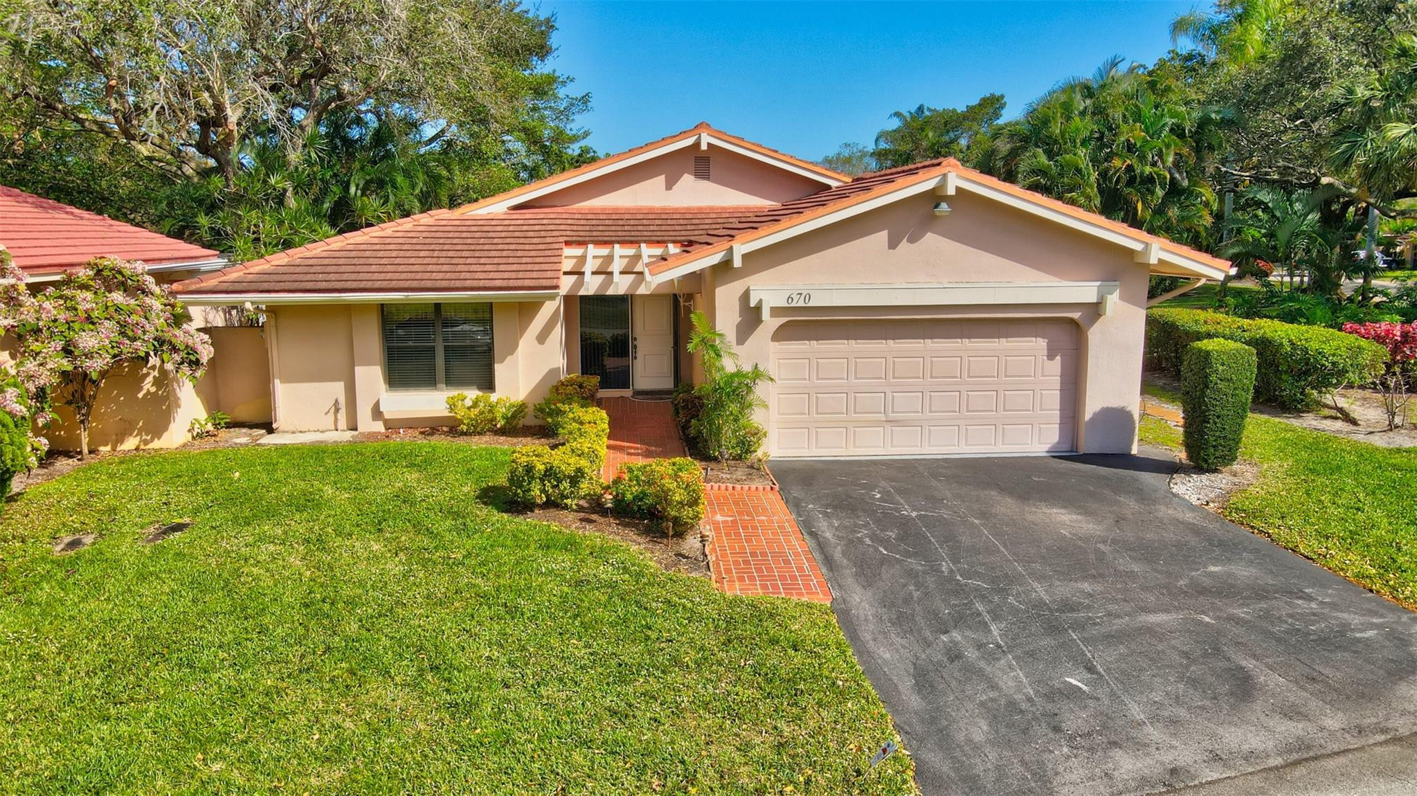 A Golfer Paradise! Living on a Golf with No membership required. Extremely well maintained 2/2, with 2 cars garage, Heated Pool CORNER LOT water view home. Foyer entry opens to bright living area w/ volume ceiling for lots of natural light. Tile flooring. Spacious dining area for family gatherings opens to a large screened patio w/  pool & Jacuzzi overlooking a relaxing private water view. Kitchen w/ wood cabinets, granite counter top & Convenient pass-thru to patio. Spacious master bedroom w/ large walk-in closet. Newer Pool Heater & Pool Pump. Washer & dryer in the garage. Roof 12 Years. A/C 7 years. Great location on a quiet street large corner lot. View of the 4th Hole green & fountain from your front door. Low HOA fees. Minutes to Deerfield Beach, Restaurants & shopping. WELCOME !!