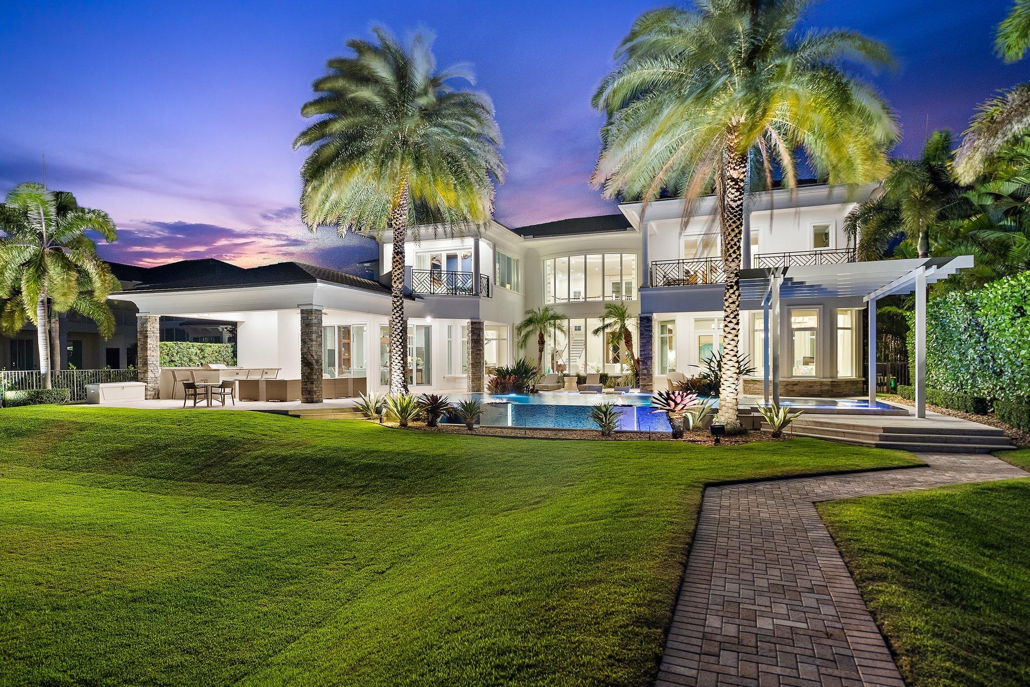 Located directly on the Intracoastal, across from the wide water opening to Loggerhead Marina - P.B.G., this amazing former model home has all the bells and whistles desired by the most discerning buyers.  Enter the grand foyer and experience two story volume with a wall of impact glass beyond the formal living room to the pool, grassy lawn, and 75' of waterfront dockage.  The master suite occupies the first floor, along with one guest suite, formal dining, den, wet bar, breakfast room, kitchen, laundry, and spacious family room with cabana bath.  The back yard boasts an amazing pool with spa, fit pits, rain trellis, and summer kitchen.  A private elevator or the grand staircase takes you to the 2nd floor with 4 guest suites, loft area, media room, and secondary laundry room Impact Glass throughout and  generator