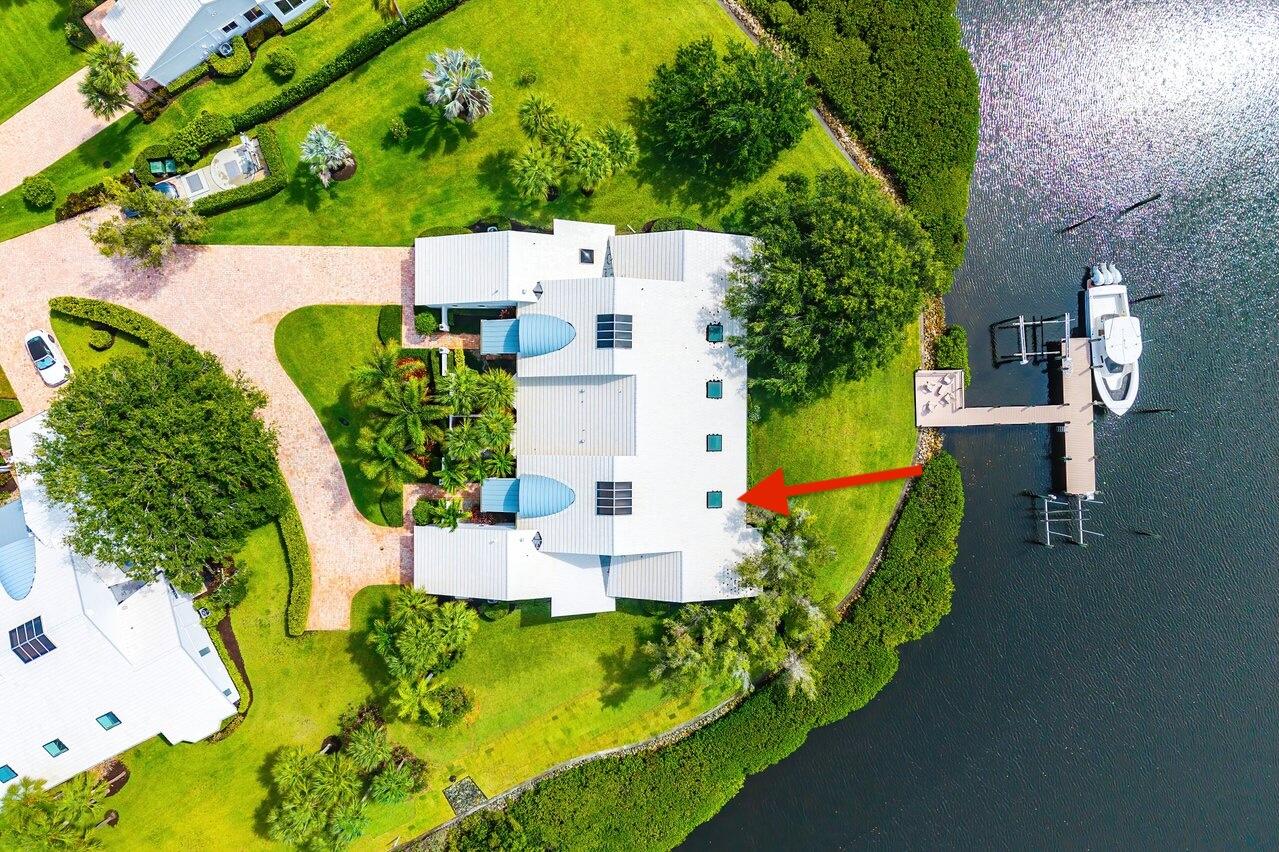 Rare opportunity to own a waterfront Villa III in Admirals Cove.  Ideally situated on an oversized end lot, this single-story residence enjoys sweeping navigable water views, a private boat slip with 16,000-lb lift, and direct access to the Intracoastal Waterway and Atlantic Ocean beyond. Significant advantage of a Golf Membership available at closing.  One of only a limited number of Villa III residences, this property offers an exceptional combination of waterfront lifestyle, privacy, and future potential. Thoughtfully designed floor plan features 2 BRs,  2.1 BAs (w/ potential for 3rd BR), expansive living areas, & a bright newly added flex room addition w/ impact windows and door.  Full-house generator  [Continued in Supplement Remarks.] A unique value-enhancement opportunity exists through the potential enclosure of the existing covered porch, creating additional air-conditioned living space for a third bedroom, office, media room, or expanded primary suite (subject to approvals).   Enjoy effortless boating from the shared dock system leading to your private slip and lift, while benefiting from a location just moments from Admirals Cove's marina, clubhouse, dining venues, golf, tennis, pickleball, fitness center, and world-class amenities.   The residence is ready for a buyer's personal vision and updates, offering the rare chance to renovate and customize a waterfront home in one of South Florida's premier golf and boating communities.