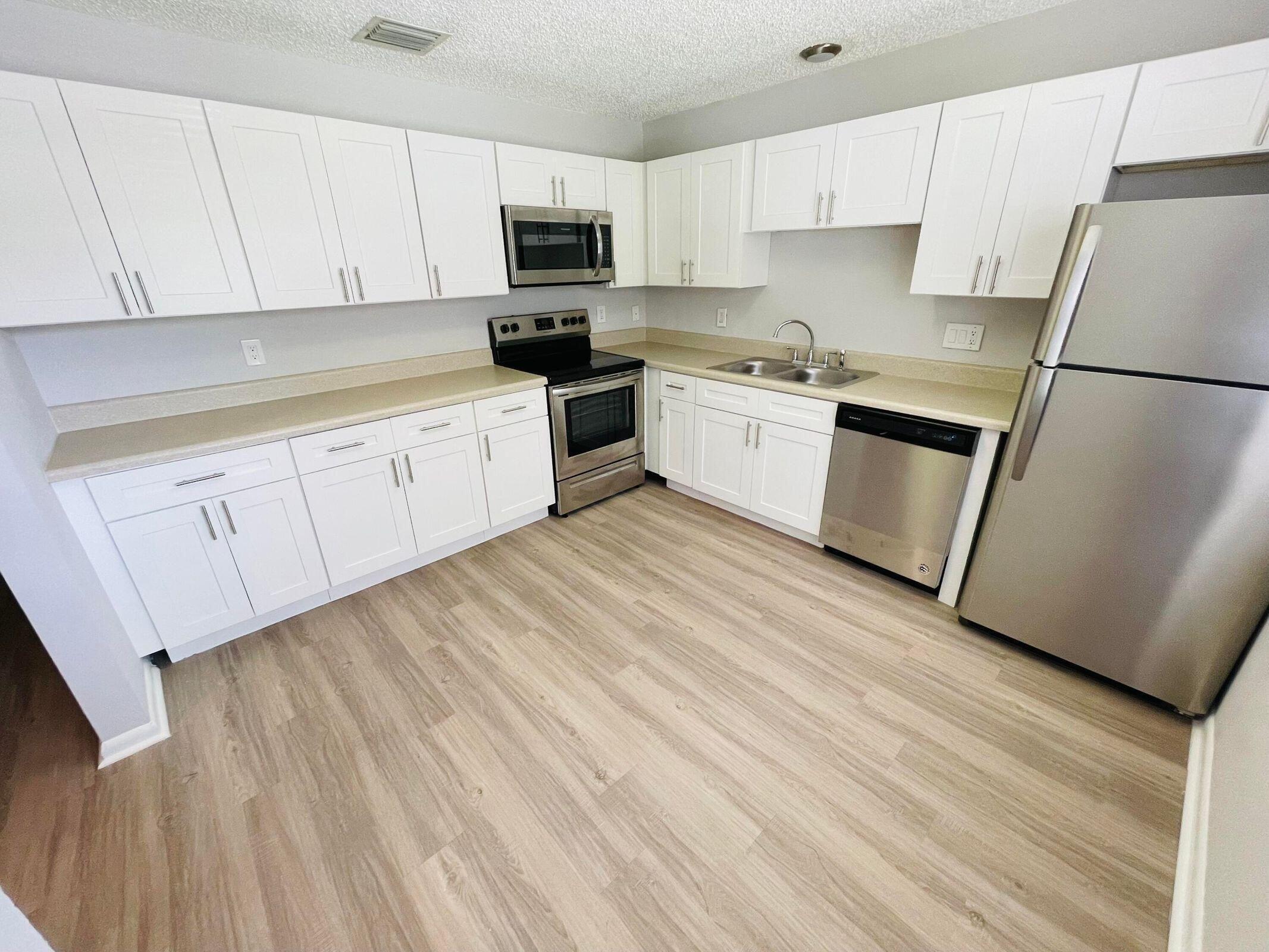 Completely Renovated villa with 2 bedrooms & 2 beautifully renovated bathrooms. Brand new kitchen with white shaker custom cabinetry, HUGE MASTER TUB with Rain-show head, plank flooring, brand new appliances, new bathrooms with custom vanities, new fixtures, all freshly painted thru out. PRIVATE BACKYARD AREA to spread out and enjoy south Florida living at its best. The biggest unit available for the price. Come today! Located near Northlake Blvd, close to beaches, shopping, restaurants, easy access to 95, only 10 minutes north of downtown West Palm Beach