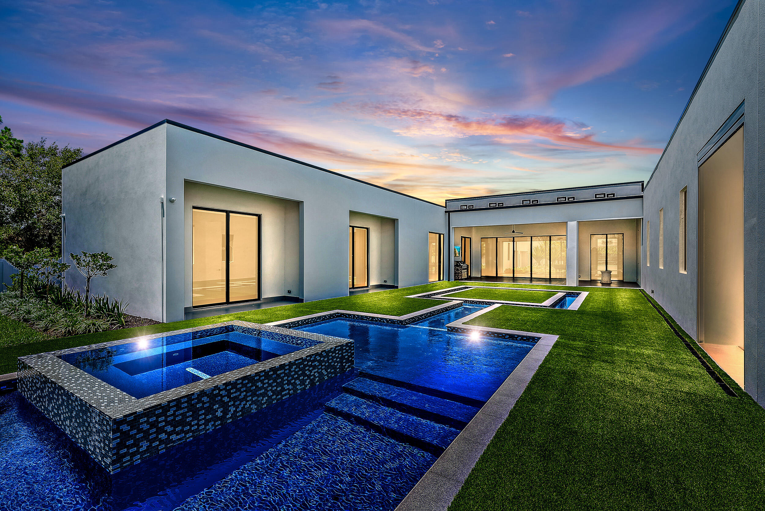 New Contemporary Home built in 2022 on over 4 acres of private Intracoastal property plus 2 acre lot next door. Perfect for the car collector or boater with 8 garages plus room for car lifts, and over a 100' of direct Intracoastal frontage. Sleek and clean lines, large floor to ceiling windows with long views of property and pool, 3 bedrooms in the main house and a detached guest suite with full bath and kitchen, theater, and office/exercise room.  Luxurious Owners Retreat with wood floors, fireplace, marble bath, dual sinks and water closets and a walk-in boutique style closet. State of the art contemporary kitchen with 2 wall ovens, wine wall, gas stove, push open refrigerators and freezer, butler's pantry & oversized walk-in pantry.
