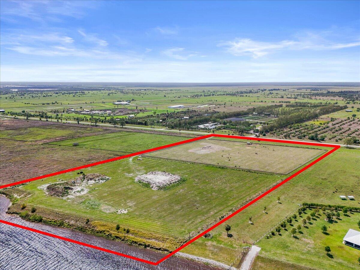 Come see this extraordinary 20+ acre waterfront property, offering ocean access and fully navigable water-presenting a rare opportunity to create the estate of your dreams. Perfectly positioned on The St. Lucie Canal and alongside the prestigious Sandglass Golf Club, this remarkable property combines scale with an elite location and fabulous sunsets!  The land has been thoughtfully improved with a solar-powered irrigation well, cattle shade shelter, and a durable concrete trough, making it both functional and versatile. Fencing spans along three sides of the property, while the waterfront boundary remains open-offering seamless access to the water and the ideal setting for you to design and construct your very own private dock.  Don't miss the chance to bring your dream estate to life!  Additional property features -  Solar powered irrigation well, Cattle shade shelter, Fenced on three sides with open boundary along the lower portion, Separate cattle enclosure with multiple access gates, Concrete cattle trough. Stunning sunsets! No fixed bridges, but there is a lock within the canal.  No gopher tortoises.  80 small slash pine trees were planted a few weeks ago. Six cattle are needed for the agricultural exemption, which can convey if you chose to apply for this. The canal runs east to west and is part of the international waterway. There is also a pad and fill that can be removed if needed.