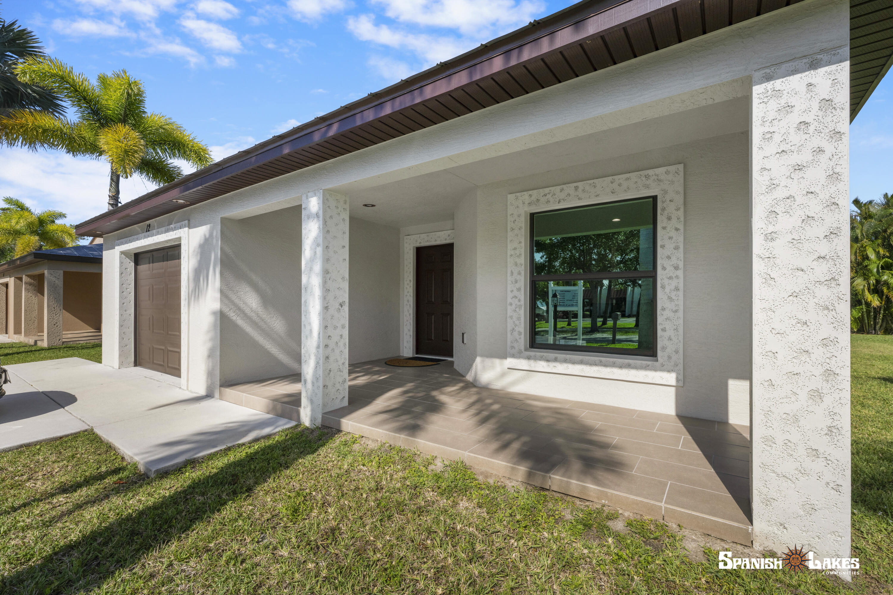 Discover true Florida living in the 2-bedroom, 2-bath Carlton model featuring a spacious layout, soaring vaulted ceilings, a covered front porch, and attached garage. Built with solid concrete block, this home boasts quartz counters, stainless steel appliances, and elegant finishes. The split-bedroom design ensures privacy while the open living area flows perfectly for entertaining. This move-in-ready home was built with 3/16th true plywood roof sheathing, hurricane tie straps, R-30 insulation, and hip roof designs ensuring big insurance premium discounts. Our homes also come equipped with energy efficient appliances, keypad door locks, and a continuous quartz kitchen backsplash. Guaranteed Fixed long term land lease: $599/month for 99 years.