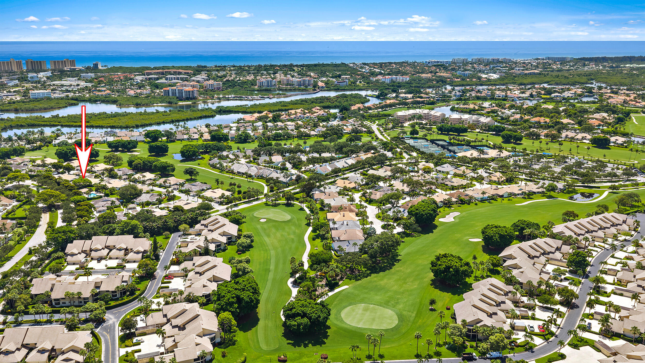 Tucked away in the picturesque Windward Village enclave of Jonathan's Landing, this inviting two-bedroom, two-bath villa enjoys a peaceful setting surrounded by lush green space and just steps from the community pool. Offering privacy, convenience, and a relaxed Jupiter lifestyle, this residence is the perfect place to call home. Inside, the split-bedroom floor plan offers privacy for owners and guests, while the spacious living and dining areas flow to a bright kitchen with sliding glass doors leading to a private patio. A screened lanai provides the perfect spot to relax and enjoy the tranquil surroundings.  Improvements include a freshly painted interior, new hot water heater (2026), HVAC (2018), front door (2018), impact windows (patio sliders are not impact), and roof replaced in 2015. Jonathan's Landing is a gated, non-mandatory golf community where club membership is optional. The pet-friendly community allows up to two pets with no size restrictions, and owners may lease once per year with a 30-day minimum. Just minutes from Jupiter Beach, the Jupiter Inlet Lighthouse, Harbourside Place, Riverwalk, waterfront dining, shopping, and beachside parks. Optional club amenities include three championship golf courses, a 257-slip marina, wellness center, spa, tennis, pickleball, bocce, kayaking, fishing, dog park, playgrounds, and more. Experience the very best of Florida living in one of Jupiter's most sought-after communities. **Virtually Staged photos used**