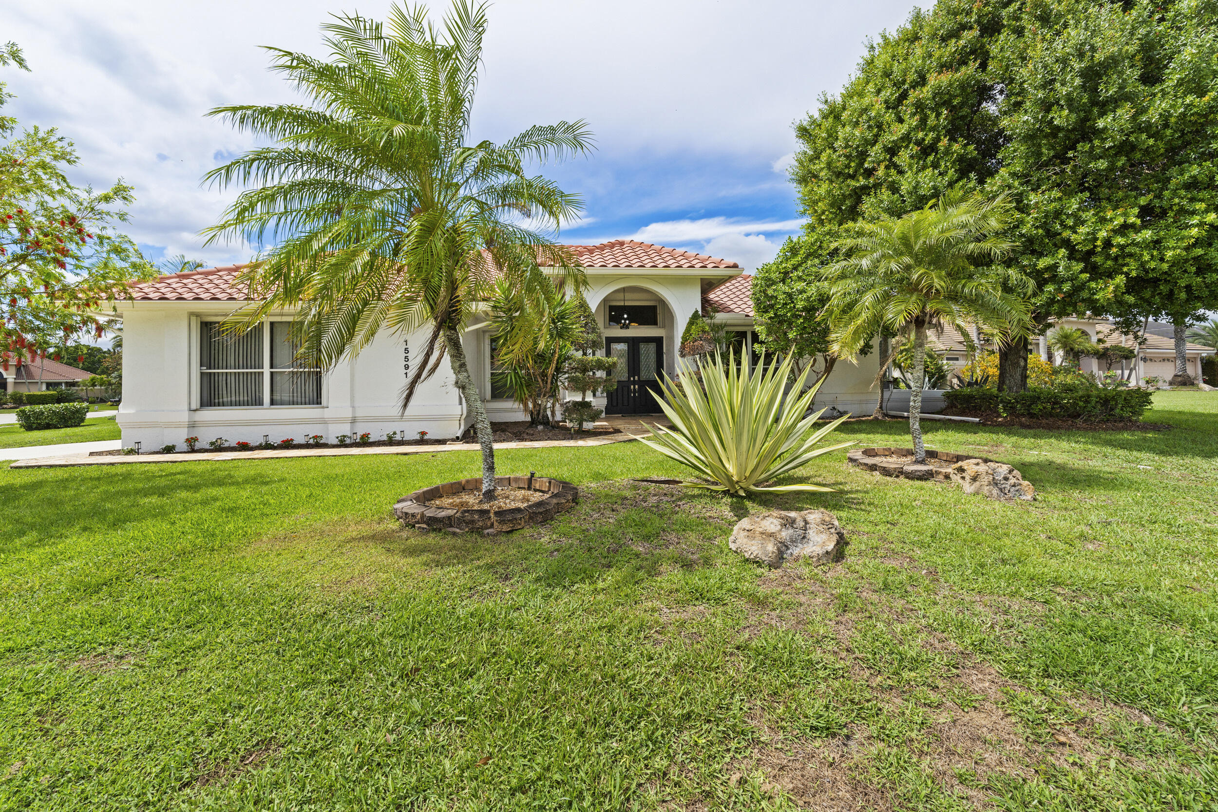 Welcome to your private retreat in the heart of Wellington! This beautifully maintained single family home is ideally situated in a spacious corner lot within a quiet cul-de-sac in a prestigious gated community surrounded by a golf course. Featuring 3 bedrooms plus a versatile den complete with a closet and easily used as a 4th bedroom. This home offers flexibility for families, guests, or a home office. Vaulted ceilings and 4 sets of French doors fill the home natural light and add timeless charm throughout. Designed for both comfort and peace of mind, the property includes full hurricane protection, a convenient side load garage and classic plantation shutters. Step outside to your own tropical oasis: a stunning screened enclosed pool area with an oversized covered lanai, perfect for   entertaining or relaxing year round, The lush, mature landscaping creates a private backyard setting. This is Florida living at its finest. Combining space, style and serenity in one exceptional home. Recent enhancements include New HVAC, New Hot Water Heater, New Pool Pump, New Sprinkler Pump, Newer Kitchen Appliances, Roof 2015. Lowest HOA in the area. Freshly painted interior and exterior. Walk in closets with closet clinic built ins. Vaulted and tray ceilings, crown molding, accordion shutters, new hurricane impact double front doors, large impact picture window in family room and 2 double hung impact windows on side of house, Located in the heart of Wellington, with easy access to the Florida Turnpike and I-95, Lakefield West is within minutes of The Wanderers Club, Palm Beach International Equestrian Center, International Polo Club Palm Beach, Wellington National Golf Club, and A-rated schools just to name a few!