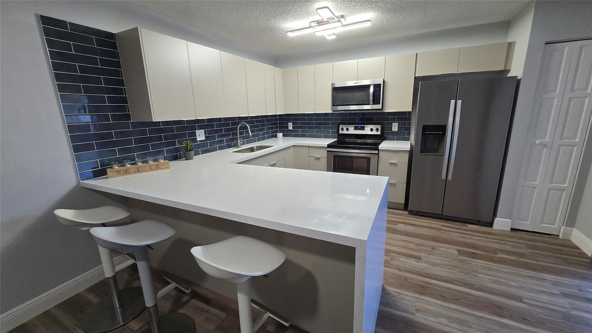 $2000 Seller Credit - Fully renovated two-story townhome in Pine Island Ridge Woodvale featuring 2 bedrooms and 2.5 baths, perfect as a primary residence or investment. Private fenced patio entry, spacious living area, and elegant waterproof laminated floors throughout. Modern kitchen with high-end cabinetry, Carrara quartz waterfall countertops, and stainless steel appliances. Large upstairs bedrooms with updated en-suite baths, new light fixtures, and stylish wood accent walls. HOA covers insurance, roof, and exterior. Includes country club membership with golf, gym, spa, pools, tennis, pickleball, dining, and landscaping. Prime Broward location near A+ schools, Nova Southeastern, Broward College, shopping, I-595, Fort Lauderdale Airport, Hard Rock, and more. No rental restrictions.