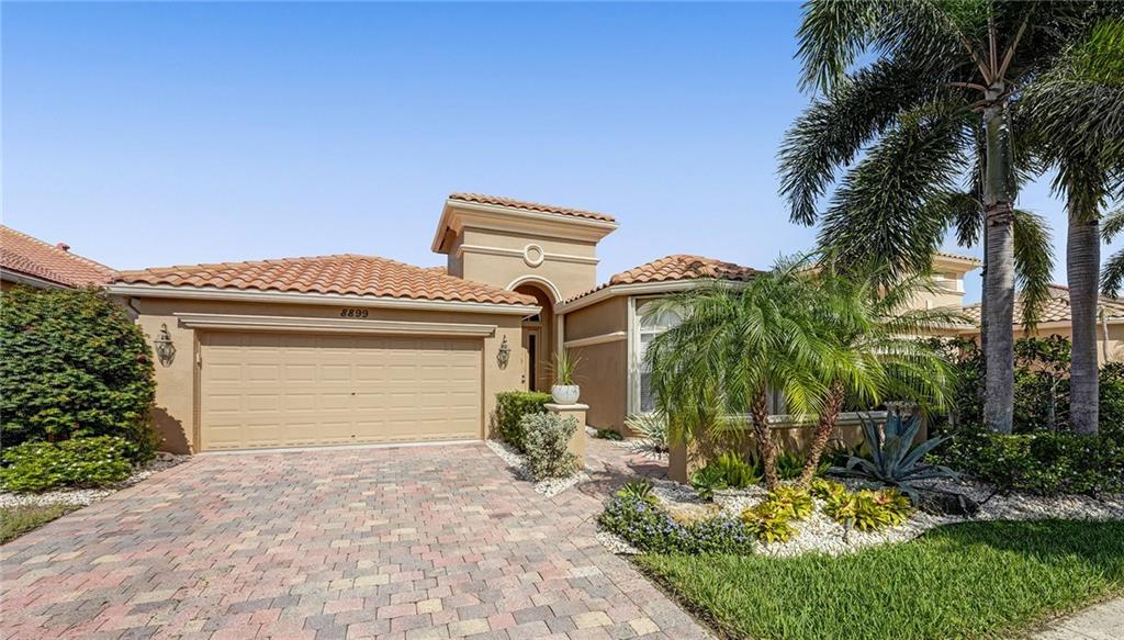 Spectacular former model in Buena Vida with beautiful designer upgrades and custom cabinetry throughout. High ceilings with stunning coffer and wood beams. Gourmet open kitchen with travertine stone backsplash, countertops and solid wood European kitchen cabinets.  Crown molding throughout and gorgeous views of the Lake. This home is meticulously maintained and new tropical landscaping. Office has custom built in cabinetry and the foyer has impressive inlaid wood. Impeccable solid hardwood flooring. Dual his and her closets. Home includes the hot tub with a view! New HVAC 2021. This is a must see. Buena Vida offers wonderful resort style amenities with Clubhouse, Tennis Courts, Community Pool and new Pickleball Court. This is Florida living a it's finest. Florida living at it's finest. Buena Vida is a premier active adult community near shopping, restaurants, golf courses and Parks. Gorgeous clubhouse and amenities.