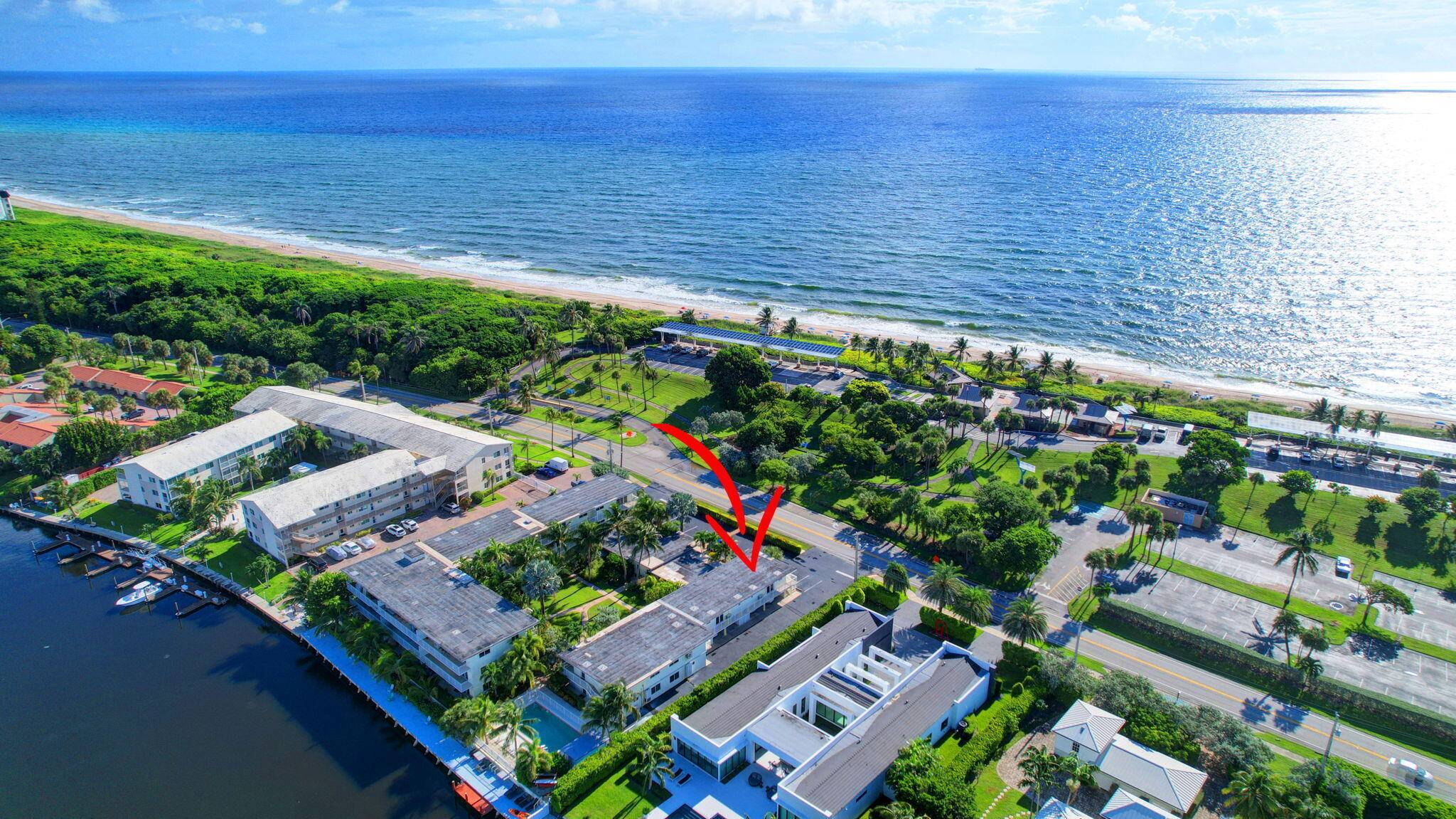 This exceptional corner unit boasts a prime location just a short stroll across the street to the stunning Atlantic Ocean! The newly renovated kitchen features sleek white cabinetry, pristine white quartz countertops, and a stylish shiplap backsplash. Complete with premium black stainless steel Samsung appliances and a deep kitchen sink, it's designed for both beauty and functionality. Luxury waterproof vinyl flooring flows throughout the unit, offering a modern look that's also low maintenance. Step onto your oversized balcony to enjoy outdoor living or take a dip in the heated pool overlooking the tranquil lagoon. The community offers extra conveniences like a storage shed, bicycle shed, and even a dock for day use which perfect for pickup and drop-off, or simply launching your kayak or paddleboard right from your own backyard. With a new air conditioner and a new panel box installed, this coastal gem is ready for you to move in and start living your dream beach lifestyle!