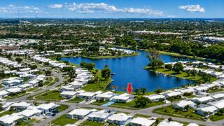 Oversized Waterfront Lot on Private Lake with boat access to Lake Osborne and Lake Ida, miles of waterway to explore . Bring your boat and fishing rod ! This Challenger Model has 2 master suites and a split floor plan. One of the largest models in this 55+ active community.  1582 square feet under A/C and a large screen patio 26 X 13. Single car garage and double driveway. This home was designed for comfort and privacy. Tile roof and flat deck 2018.  Updated electrical panel. Priced well below recent sales on this lake, needs some updating. Pet friendly community with LOW HOA fees 245.00 per month, Includes:  Cable, Internet, Lawn maintenance, sprinklers, club house, fitness center and heated pool. Rec lease paid in full. All Information is deemed correct but not warranted.