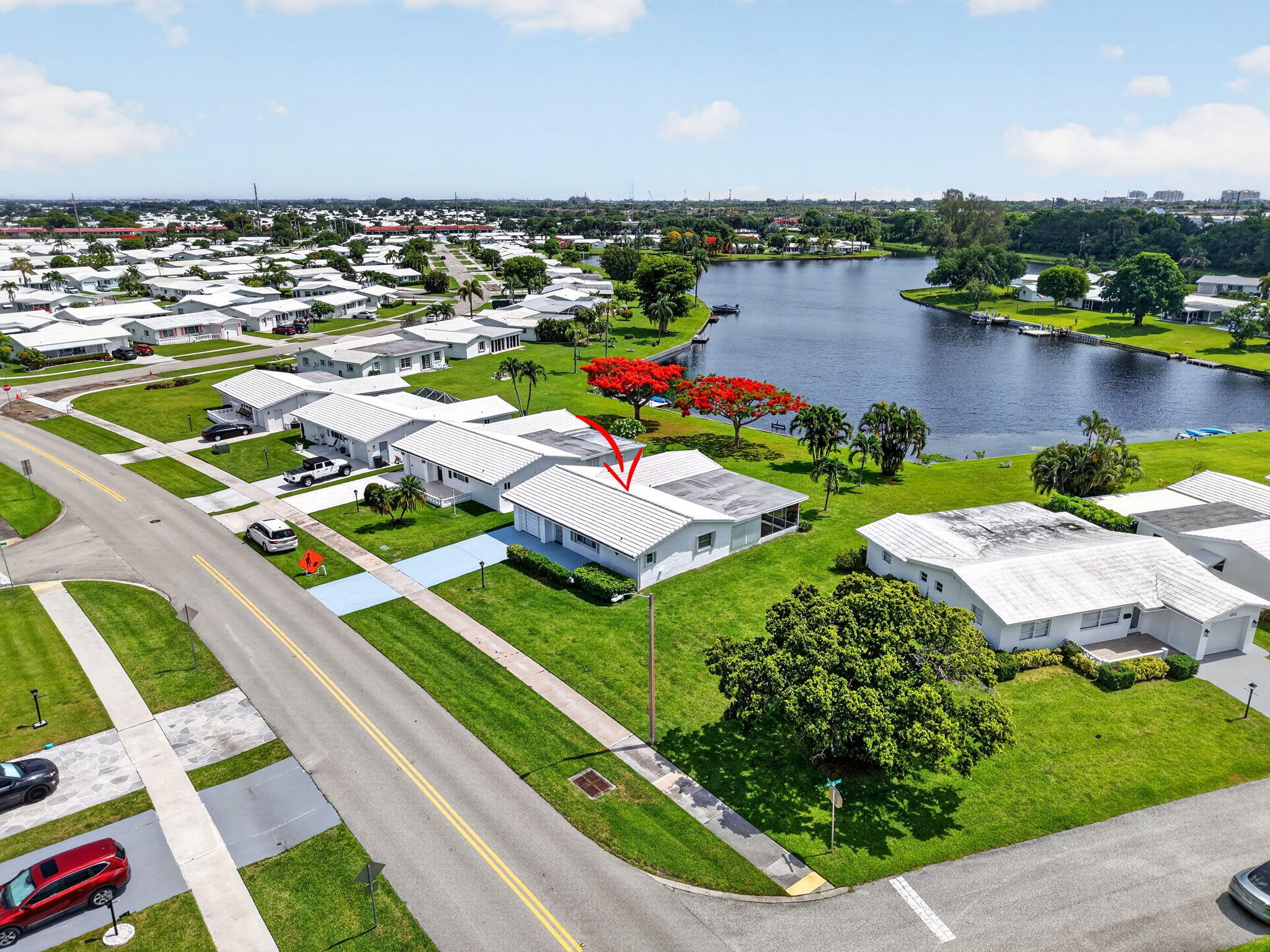 Oversized Waterfront Lot on Private Lake with boat access to Lake Osborne and Lake Ida, miles of waterway to explore . Bring your boat and fishing rod ! This Challenger Model has 2 master suites and a split floor plan. One of the largest models in this 55+ active community.  1582 square feet under A/C and a large screen patio 26 X 13. Single car garage and double driveway. This home was designed for comfort and privacy. Tile roof and flat deck 2018.   Priced well below recent sales on this lake, needs some updating. Pet friendly community with LOW HOA fees 245.00 per month, Includes:  Cable, Internet, Lawn maintenance, sprinklers, club house, fitness center and heated pool. Rec lease paid in full. All Information is deemed correct but not warranted.