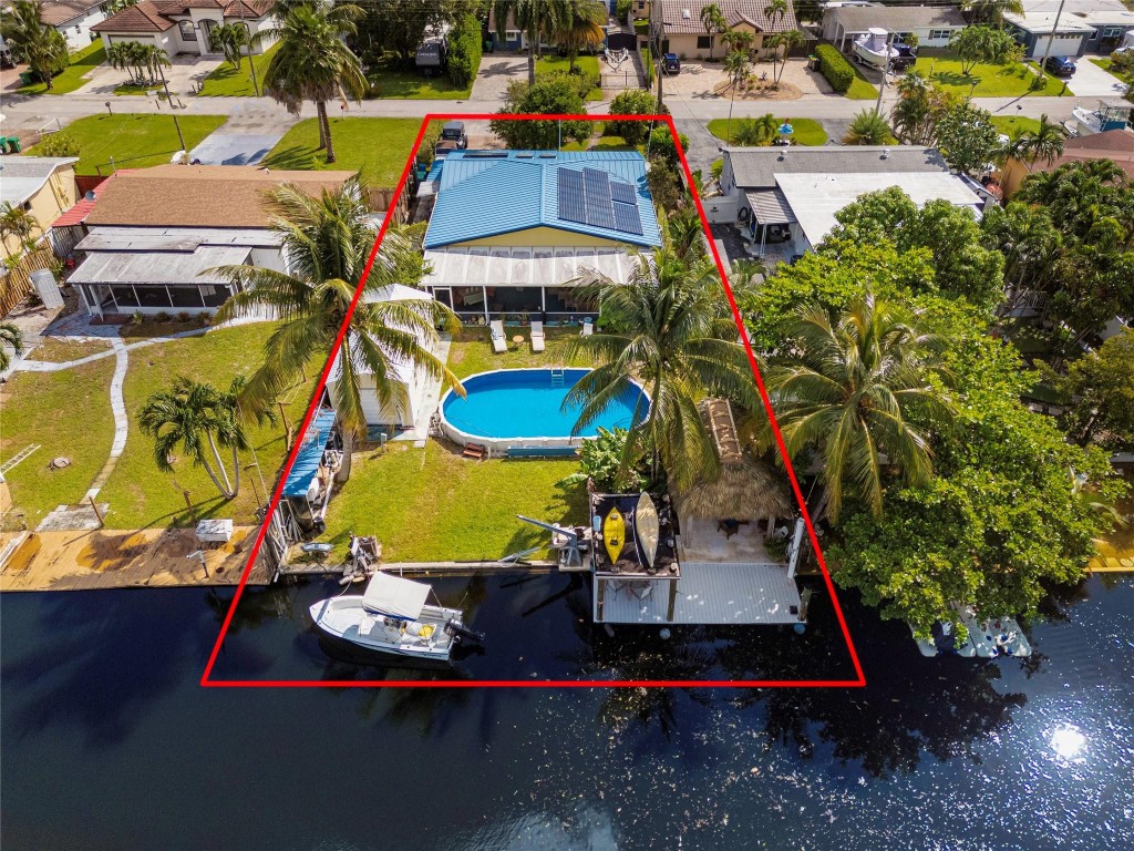 REDUCED PRICE!  MOTIVATED, OCEAN ACCESS, WALK TO WORSHIP, Spacious, Completely remodeled in 2017. All new electric, Solar HOT H2O throughout, electric bill under $200. All new Plumbing. Cast Irion pipes to PVC! RO Water treatment, Whole house water filter. Newer Metal Key West roof, Hurricane impact windows and doors. All new insulation throughout, New Ceramic tile throughout, Kitchen, New wood soft close cabinets, Granite countertops, Stainless appliances, Bathrooms, all remodeled. Substantial size screened patio, Paradise awaits! New thatched Tiki Hut and Gazebo, Composite dock,25'x10', 60' reinforced seawall. Pump and well.15,000lb boat lift.  Close to Hard Rock, Ft. Lauderdale airport, great restaurants. Close to Turnpike and I-95 Possible seller financing, call agent 4 details. Close to Hard Rock Hotel, Ft. Lauderdale airport and many great restaurants. Close to Turnpike and I-95, but not too close