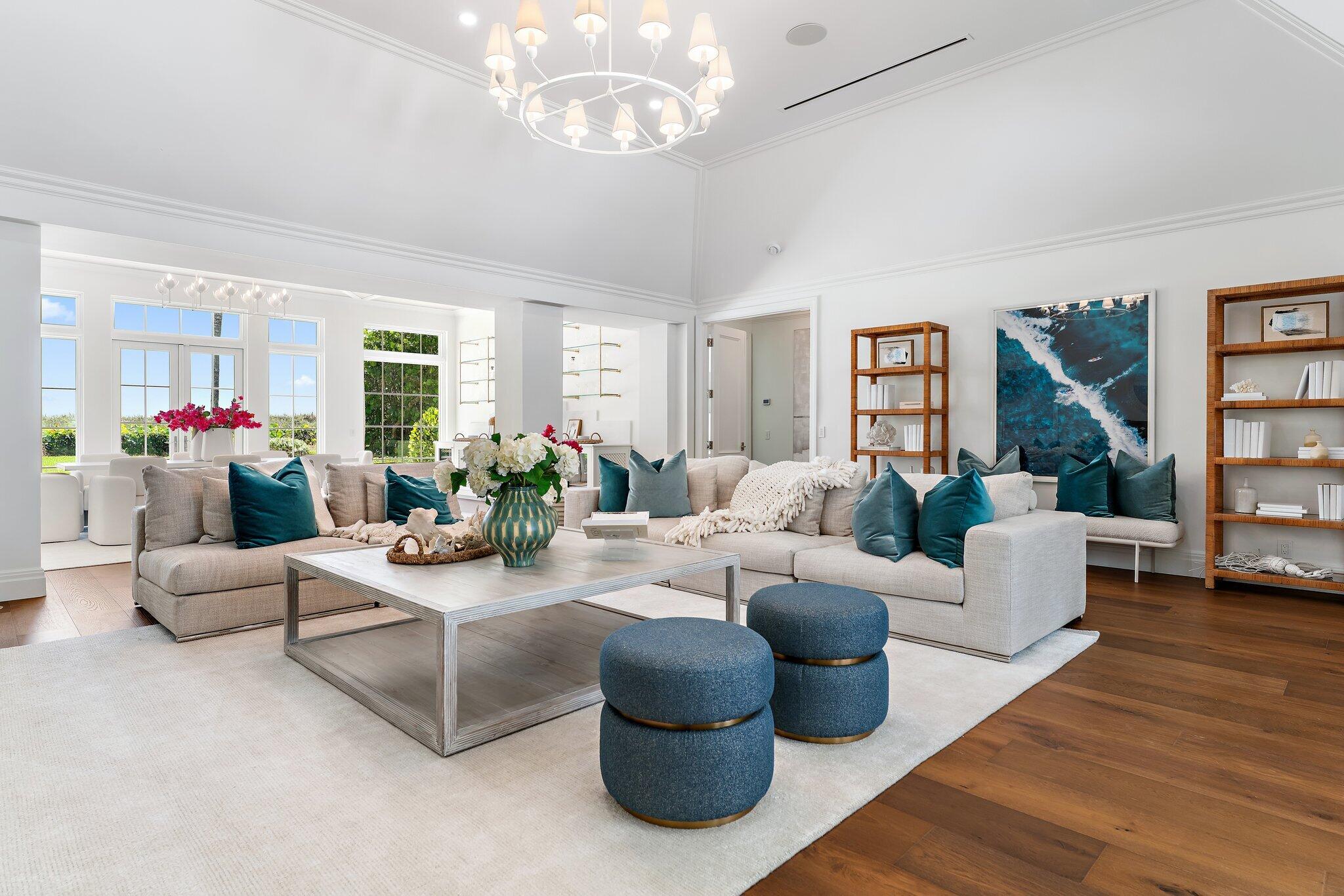 Set on nearly an acre with 100 feet of direct ocean frontage, this fully renovated Bermuda-style estate offers the best of Jupiter Island living. Convenient access to Bridge Road places you minutes from Stuart Airport and many of the area's premier golf courses. A circular drive with a motor court welcomes you to the property. Upon entering the courtyard, the pool and spa serve as the estate's centerpiece, framed by the main house to the east, a cabana to the south, and a two-bedroom guest house to the west. The layout provides exceptional privacy in the main residence while offering comfortable guest accommodations with a private kitchen, laundry, and standalone amenities. The main house sits directly on the sand and features a spacious great room and dining area with 14-foot ceilings, a kitchen with pantry, laundry room, den/office, powder room, and expansive primary suite with separate baths and closets. Offering next level finishes, the home includes Wolf and Sub-Zero appliances, a cypress-paneled den, and Kolbe impact windows and doors. The two-bedroom guest house offers two ensuite bedrooms with beautiful views of the pool and courtyard through French doors. The cabana includes a large kitchen, great room, additional laundry room, and guest bath with easy access to the pool area. The three-car garage has 14-foot ceilings, allowing for car lifts that could create space for up to six vehicles. Additional features include a Lutron lighting system, security system with cameras, AV system, generator, Cat-6 wiring, and more. Don't miss this rare opportunity to create a lasting family compound on Jupiter Island.
