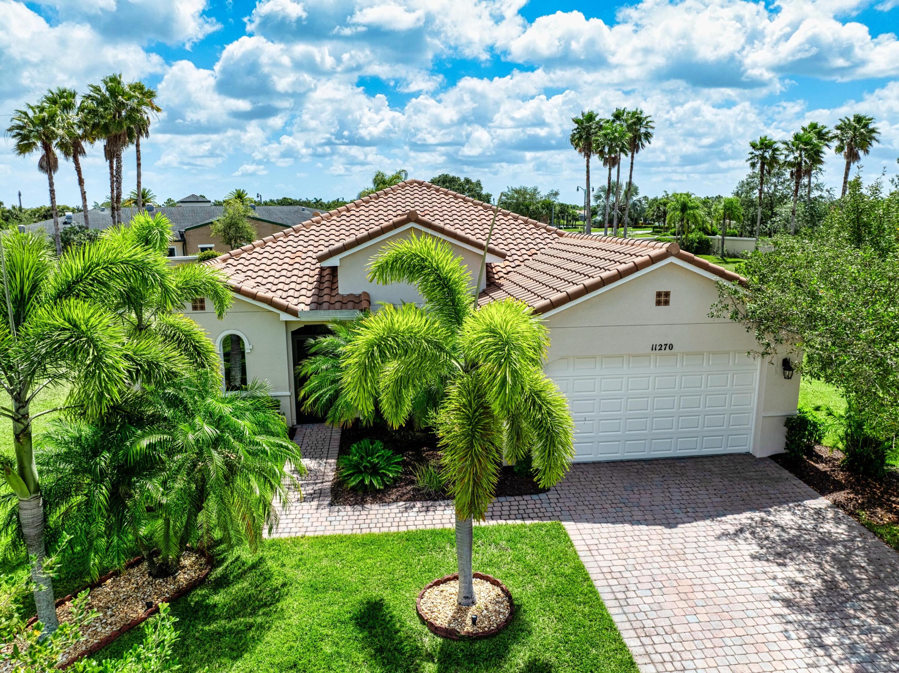 This stunning 3-bedroom, 3-bathroom home in Vitalia at Tradition with a spacious den offers the perfect blend of indoor comfort and outdoor luxury, all set on one of the largest pie-shaped lots in the community. The showpiece of the property is the expansive lanai, featuring a remote-controlled storm shade and elegant travertine flooring, which frames a spectacular saltwater heated pool—your own private retreat designed for year-round enjoyment and entertaining. Inside, the home boasts just under 2,300 square feet of thoughtfully designed living space with a bright and open layout. The large kitchen, dining, and living area flow seamlessly together, centered around a massive kitchen island that's perfect for gathering. A chef's dream, the kitchen is equipped with 42-inch cabinets, a natural gas range, and ample counter space, offering both style and functionality. This home offers dual oversized master suites, each with its own walk-in closet, dual vanities with his-and-her sinks, and modern stand-up showers ideal for privacy, comfort, or multi-generational living. A third bedroom and full guest bath are located at the front of the home, providing a quiet and separate space for visitors. A spacious, versatile den adds even more flexibility, making an ideal home office, hobby room, gym, or media space. With its resort-style pool area, upgraded finishes, and unique lot size, this home is a rare gem that combines everyday convenience with exceptional outdoor living within stunning Vitalia at Tradition.