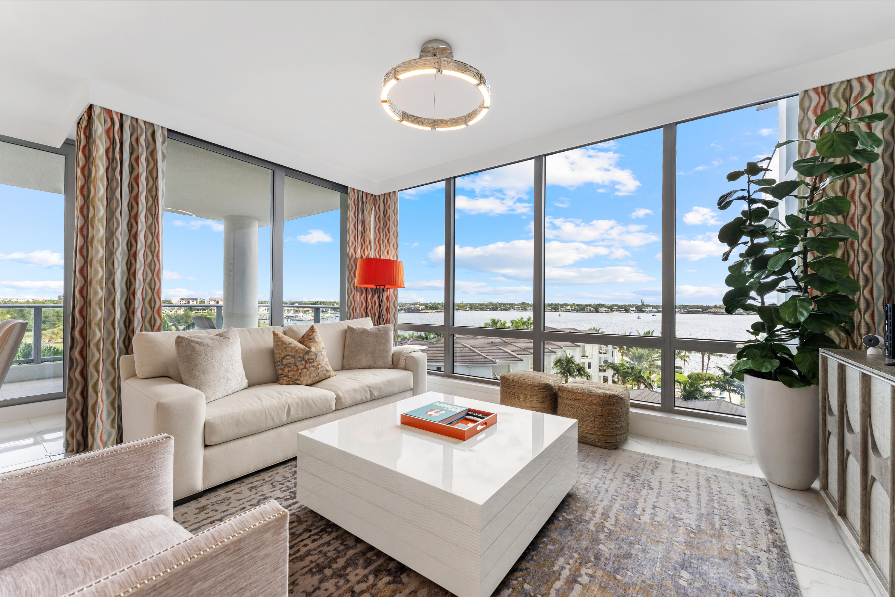 Spectacular designer residence at Water Club with breathtaking panoramic water views. Floor-to-ceiling glass fills the home with natural light, while a private elevator entry provides comfort and privacy. Offering 2 bedrooms, 2.5 baths and a designated office/den, this is an ideal turnkey, lock-and-leave residence. Two private balconies - one east for water and sunrise views, one west for sunset skies. One of Palm Beach County's most prestigious waterfront communities, amenities include 24/7 concierge and manned gate, private marina with resident day dock, three pools, two hot tubs, two fitness centers, locker rooms with steam and sauna, beach cabanas, club room, pickleball court, dog park, and resident hotel suites. Pet friendly - up to three pets and no size restrictions.  Furniture negotiable. Located minutes from the area's best restaurants, GOLF and shopping. Easy access to I-95 and FL Trnpk, PBI Airport, Palm Beach, West Palm and Jupiter. TRULY SPECTACULAR VIEWS!