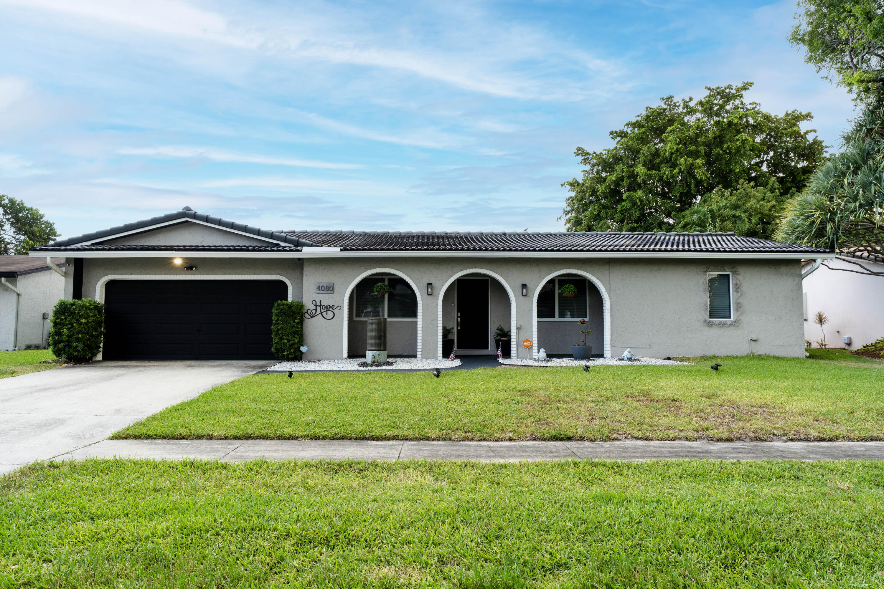 Welcome to this charming 3-bed, plus den/office, 2-bath single-story residence in Coconut Creek. Experience peace of mind with NO homeowners association. Offering 1,776 square feet of comfortable living space. Experience complete tranquility in your resort-style backyard pool. This waterfront property provides a distinctive setting within the established community. The open floor plan maximizes the interior layout across one story, making daily living convenient and accessible. A 2-car garage provides ample vehicle storage and protection. Whether you're seeking a waterfront escape or a well-proportioned home with thoughtful design, this residence offers solid value in a well-established community. Home features hurricane-impact windows throughout, a NEW hurricane-impact front door and garage door, upgraded kitchen and bathrooms, upgraded flooring, new pool pump, new washer/dryer, newer A/C and water heater, all-new Kitchen appliances, and much more! Located within walking distance of two amazing community parks.